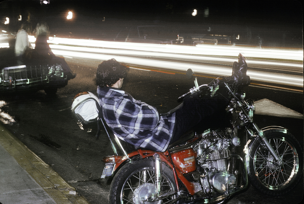 Guy reclining on his motorcycle