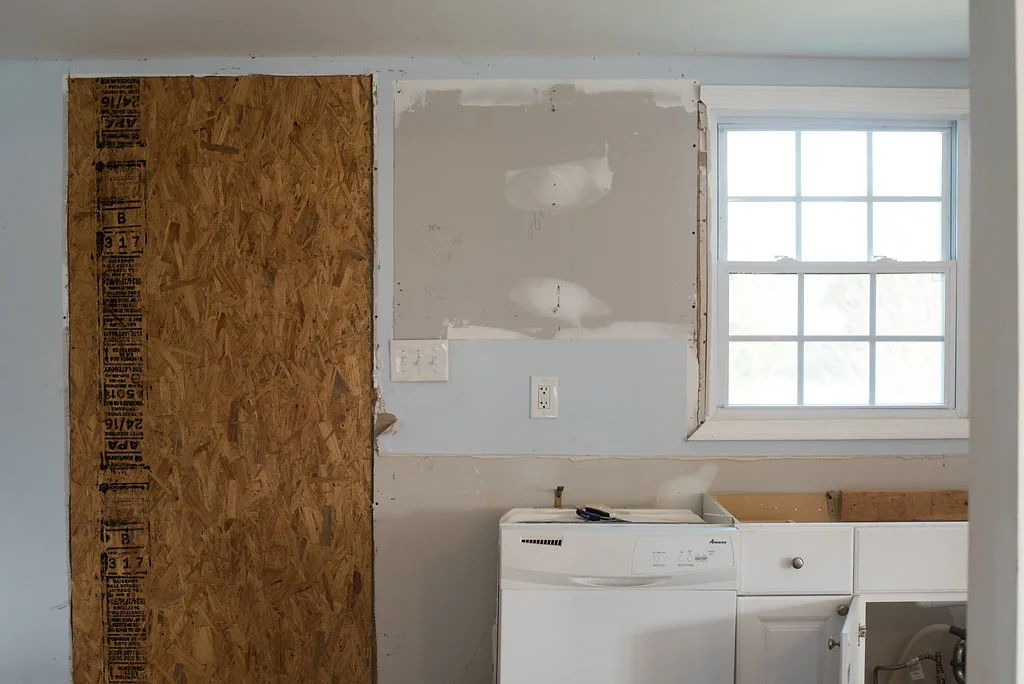 The "old" kitchen. A door use to be where this piece of plywood is. While one of the contractors thought I was nutes for closing it in, it was a happy day when the crew finally saw my vision! | PC: Emily Reedstrom
