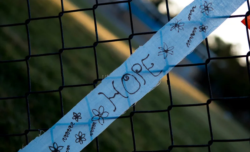 Flags include messages of hope and peace. 