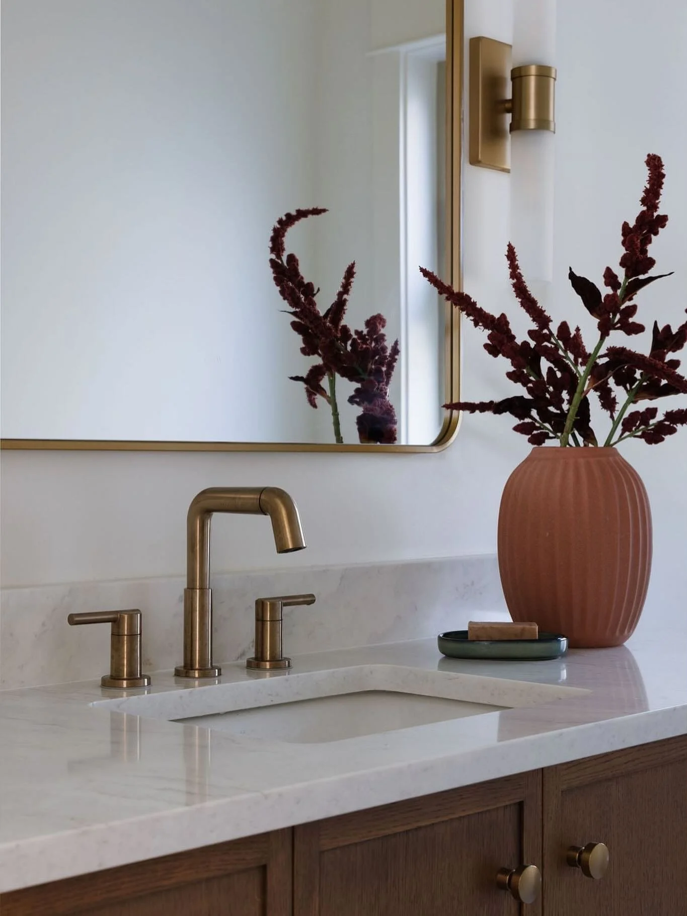 Beautiful powder room details from our Grand Boulevard home renovation project. Layered materials, rich wood tones, warm metals and subtle texture all come together in a space designed to be both timeless and inviting. 

Photographer: @mmk_creative 
