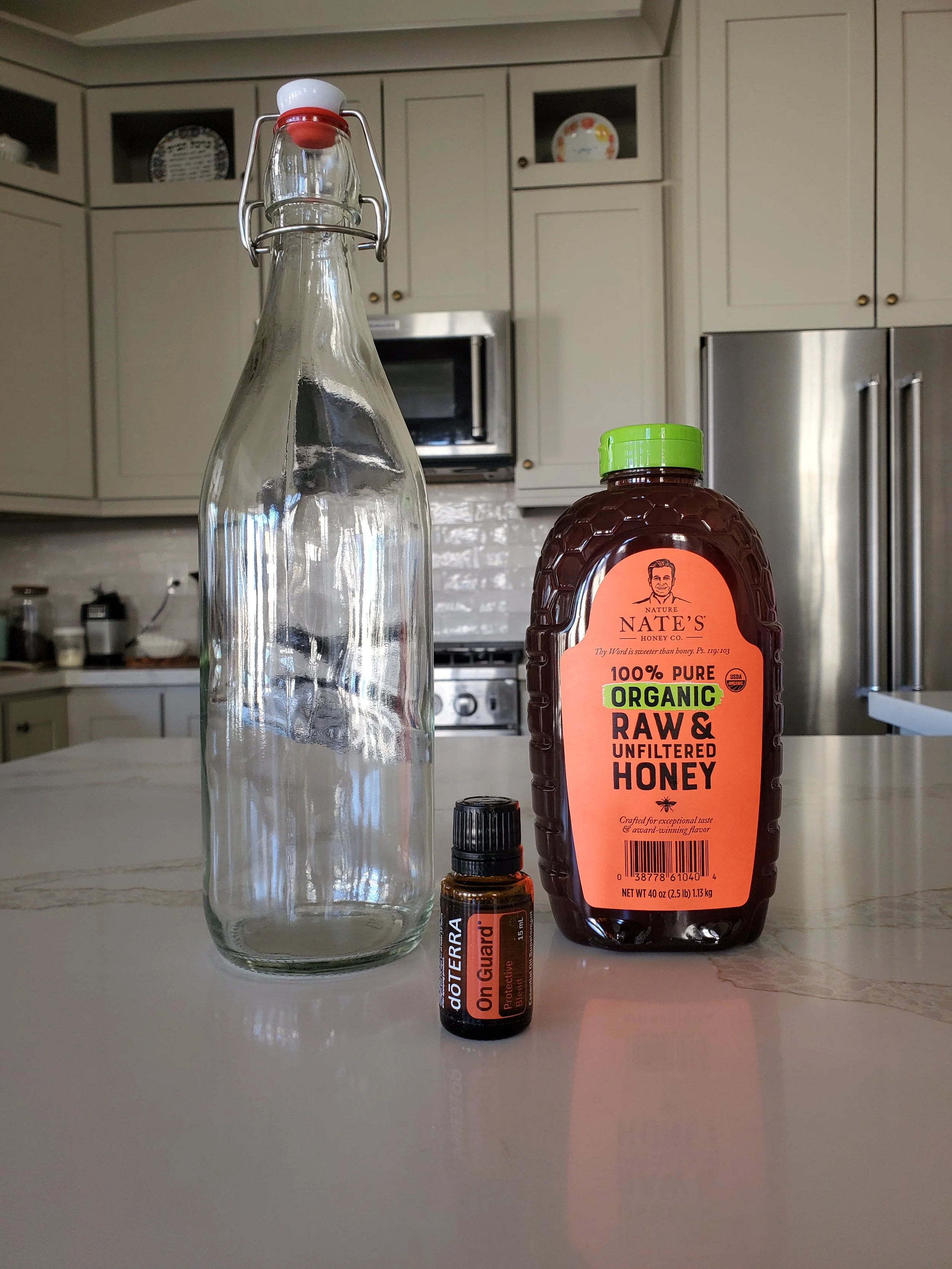 Flip top bottle, raw honey and On Guard essential oil