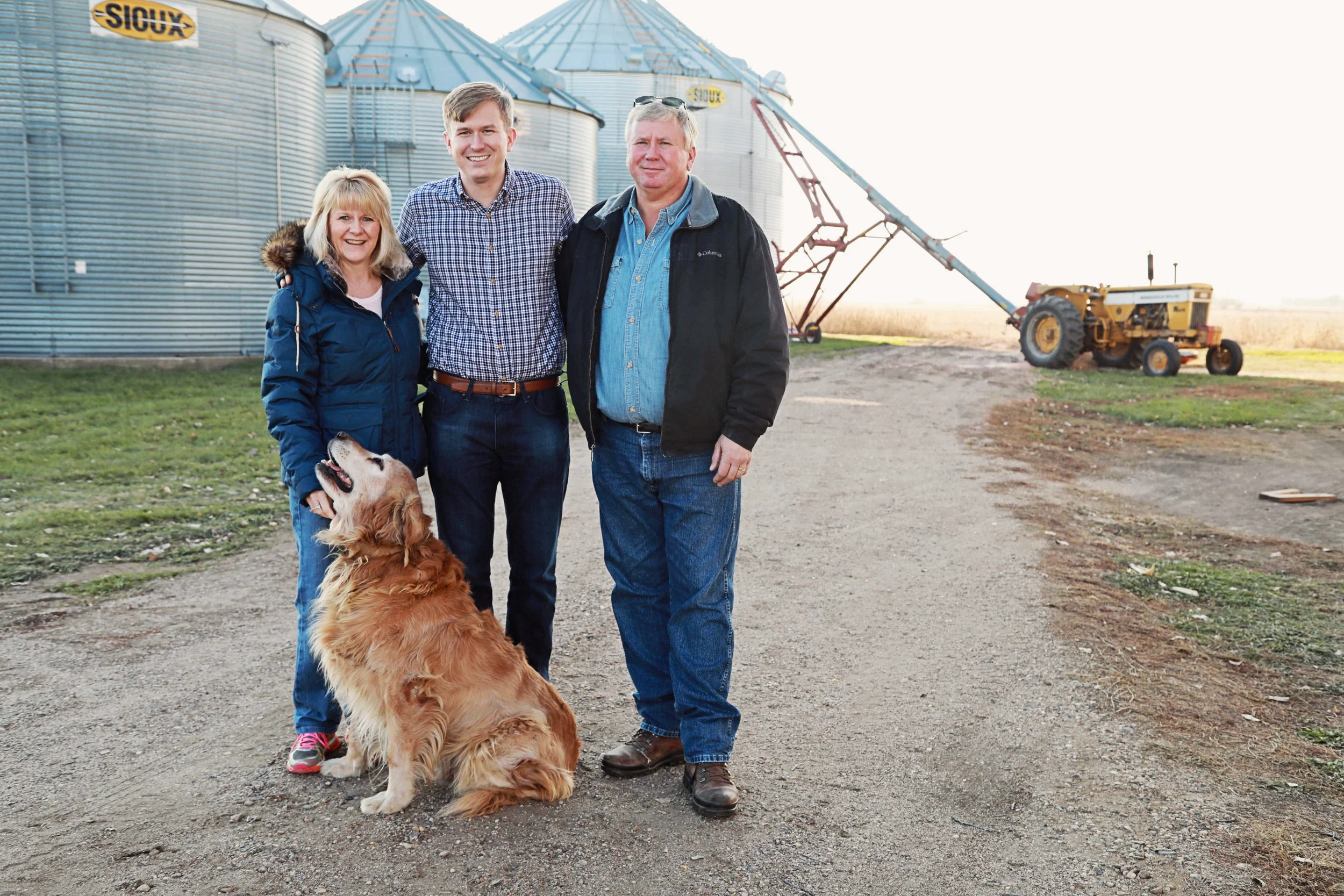 Ryan with his mom Traci and dad David and the family dog Bo at the family farm.