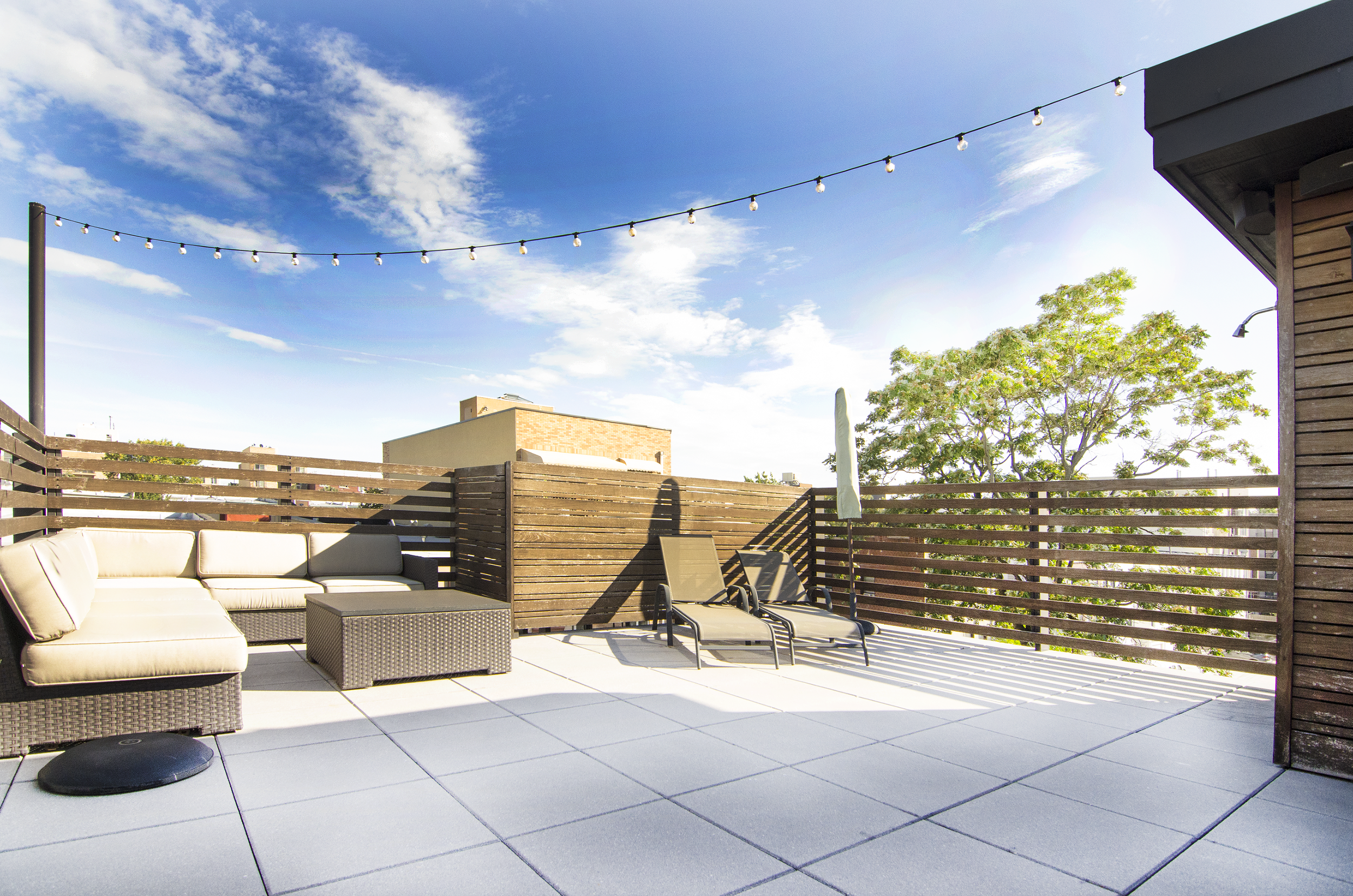 Roof Deck: Ipe railings and rain-screen walls, with concrete paving tiles.