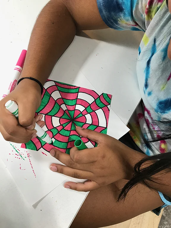 Elizabeth works on an Op Art project.