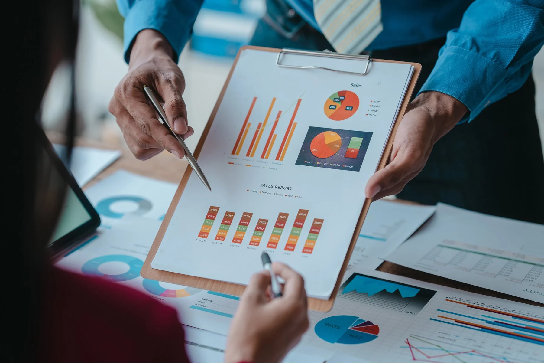 Image of a business plan writer showing the client financial charts.