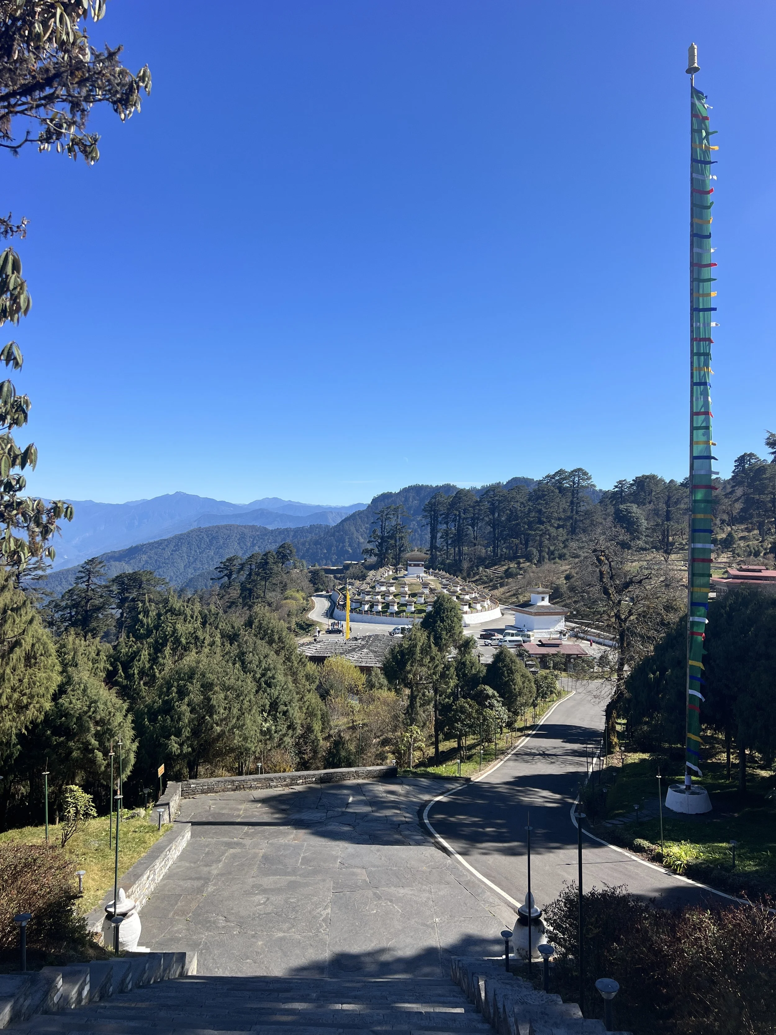 Scenic view of Dochula Pass featuring 108 memorial chortens against the eastern Himalayas in Bhutan
