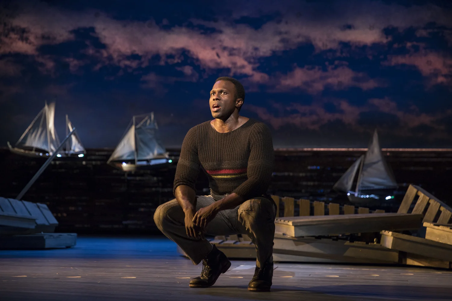 Joshua Henry in CAROUSEL; sets by Santo Loquasto. Photo by Julieta Cervantes