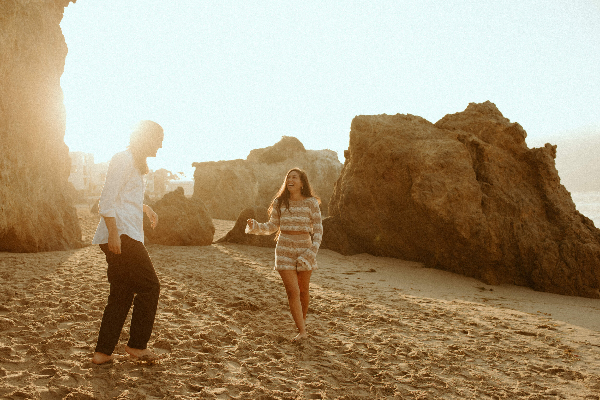 Sunrise Malibu Couples Photos | El Matador Beach Engagement Session | creative couples poses | sunrise at el matador beach | earthy neutral color couples outfits