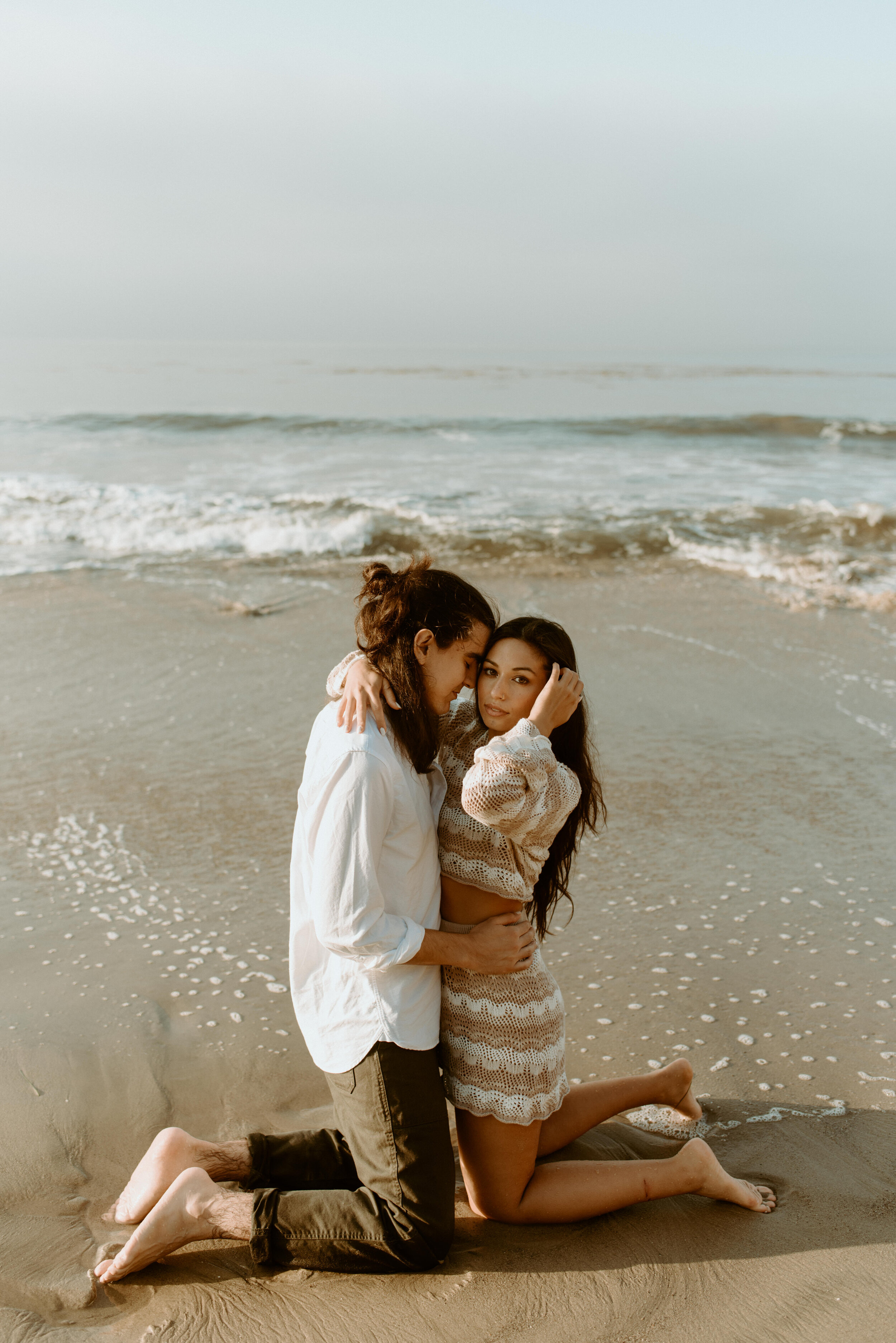 Sunrise Malibu Couples Photos | El Matador Beach Engagement Session | creative couples poses | sunrise at el matador beach | earthy neutral color couples outfits | couple in ocean water