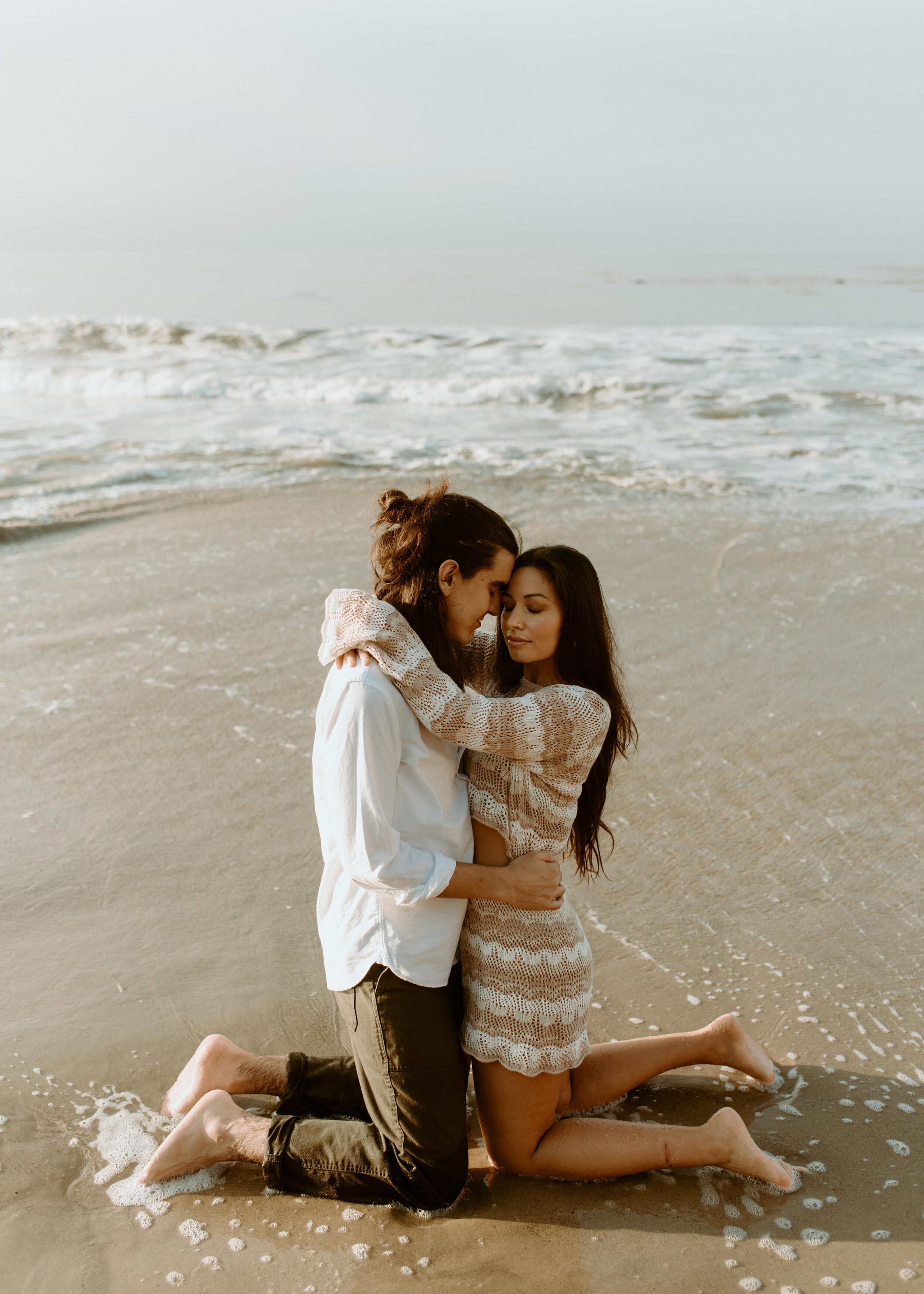 Sunrise Malibu Couples Photos | El Matador Beach Engagement Session | creative couples poses | sunrise at el matador beach | earthy neutral color couples outfits | couple in ocean water