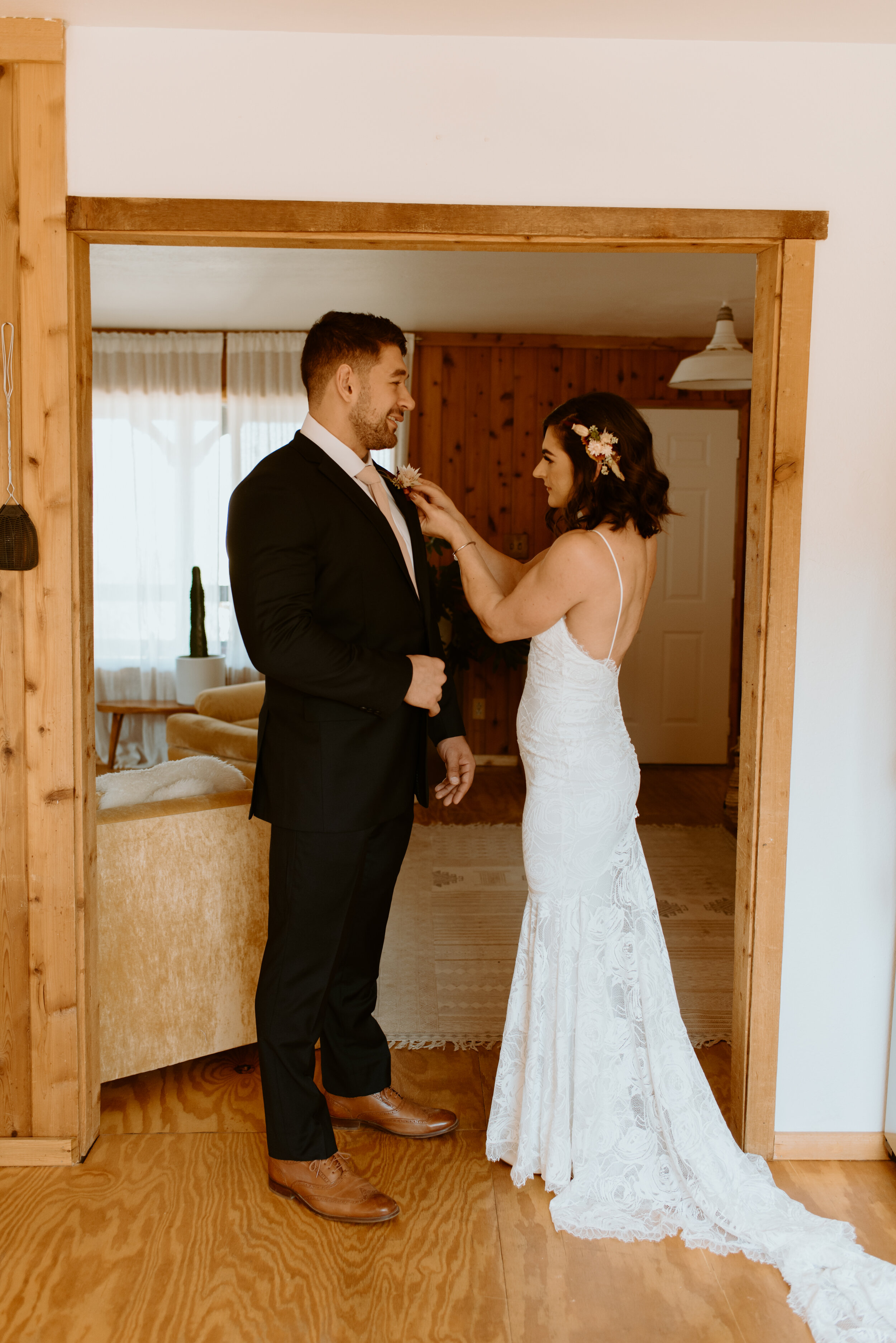 Laid-back Joshua Tree elopement | Boho bride in Grace Loves Lace dress | Joshua Tree elopement photographer | couple getting ready at airbnb for elopement