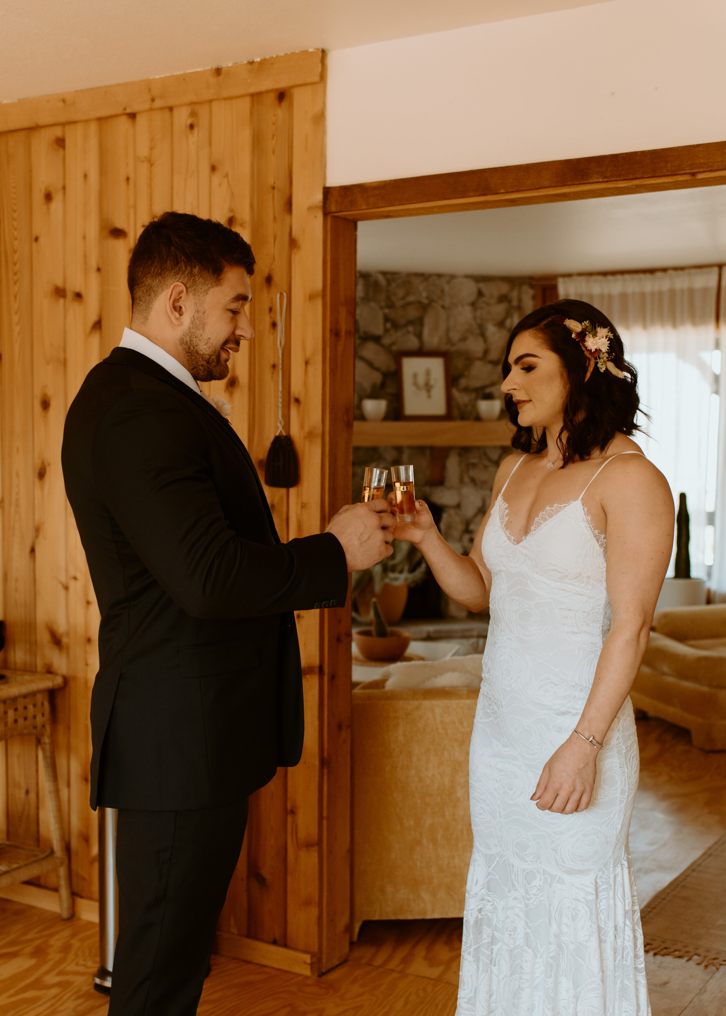 Laid-back Joshua Tree elopement | Boho bride in Grace Loves Lace dress | Joshua Tree elopement photographer | couple getting ready at airbnb for elopement