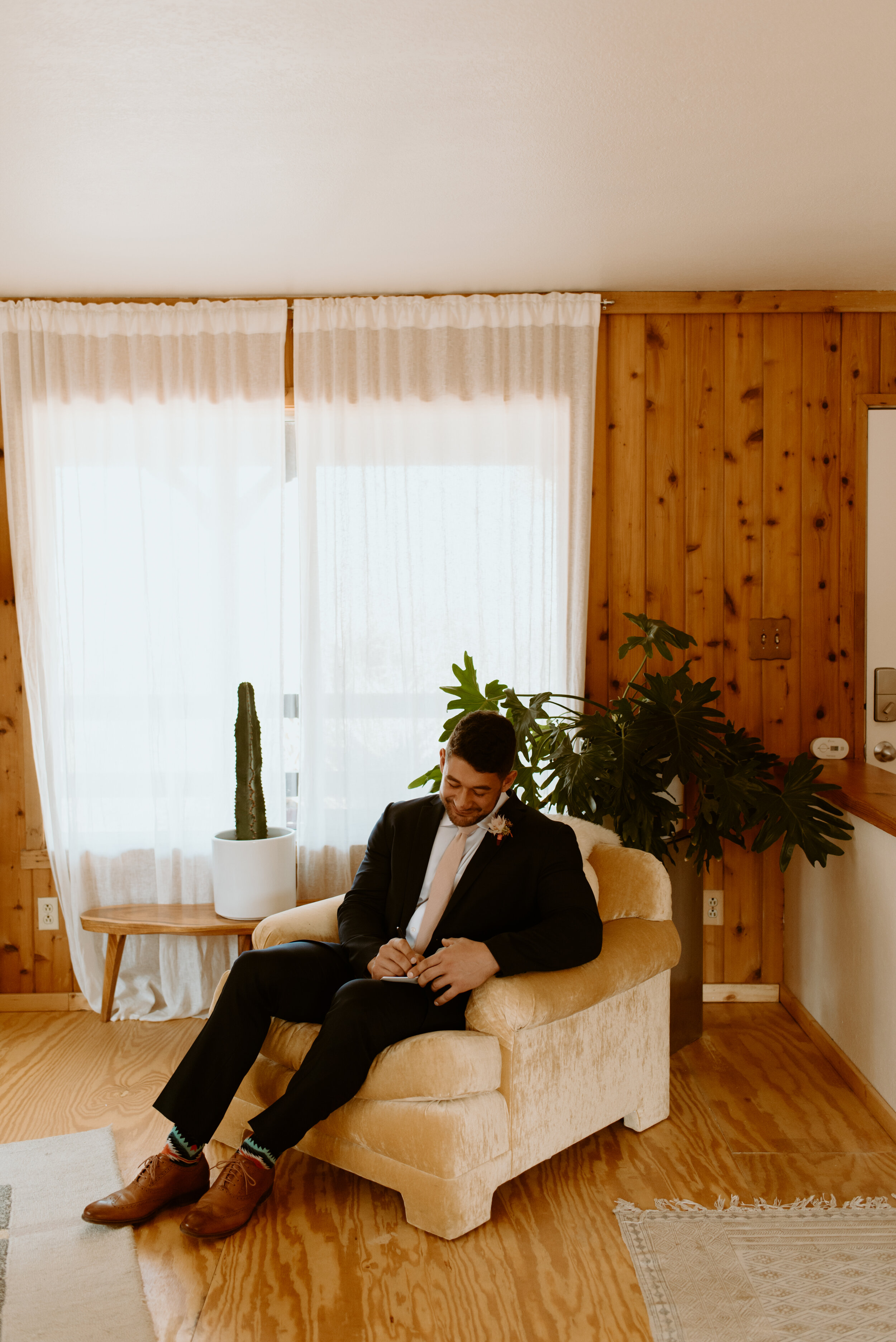 Laid-back Joshua Tree elopement | Boho bride in Grace Loves Lace dress | Joshua Tree elopement photographer | couple getting ready at airbnb for elopement