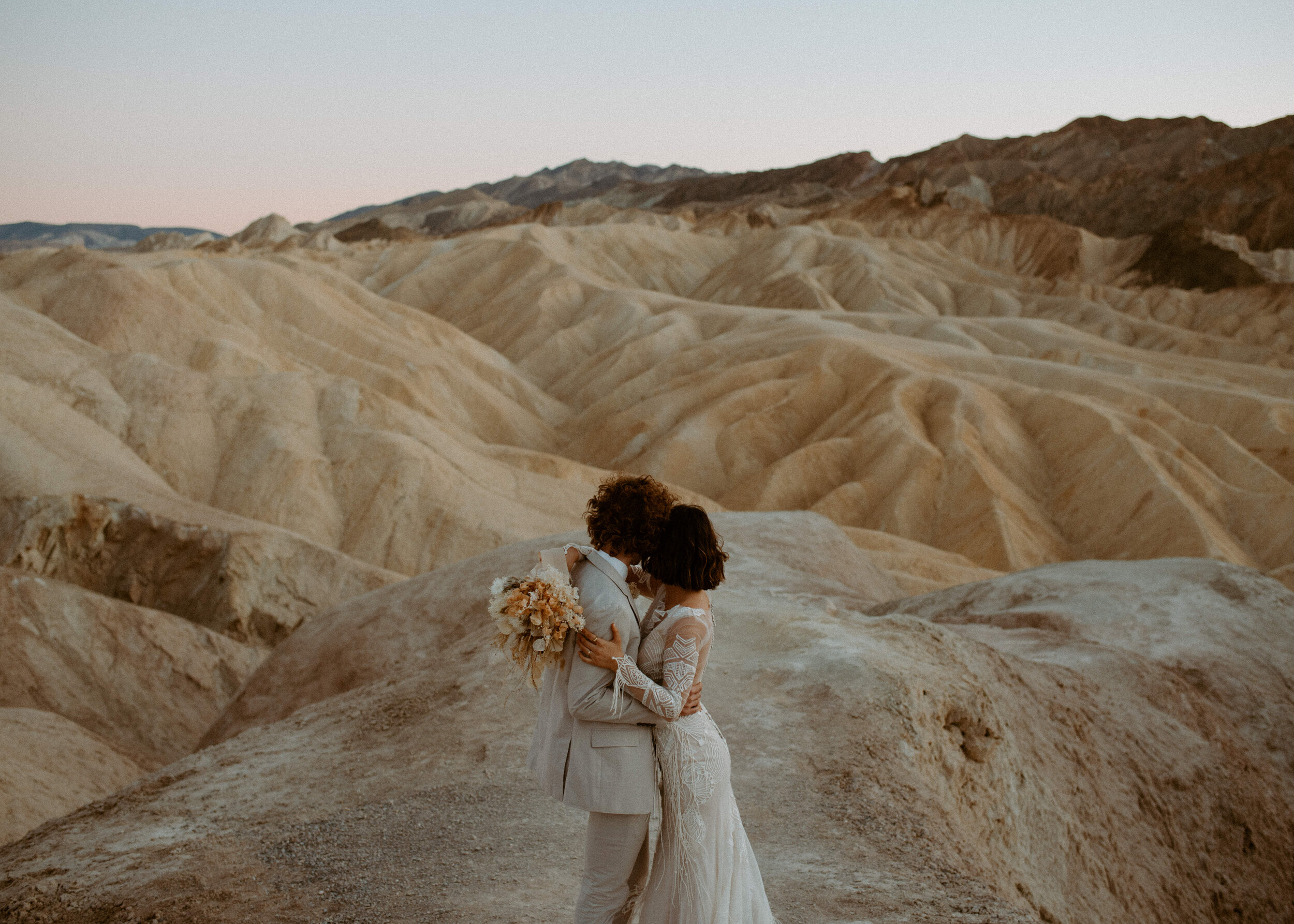 Death Valley National Park elopement | Zabriskie Point, Death Valley | California Elopement photographer | Death Valley wedding | neutral boho desert elopement | Daci Gowns | Dried floral bouquet