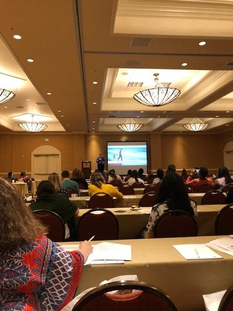 Dr. Abigail Weissman provides the morning Keynote for the Diversity in Parenting Conference. Here she is in the front of the room presenting on who are queer and trans parents.