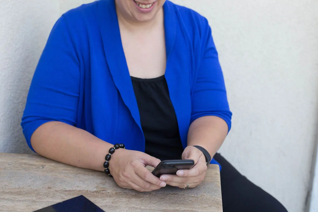 Dr. Abi Weissman checks her  phone.