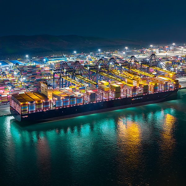 A cargo ship docked at the port at night