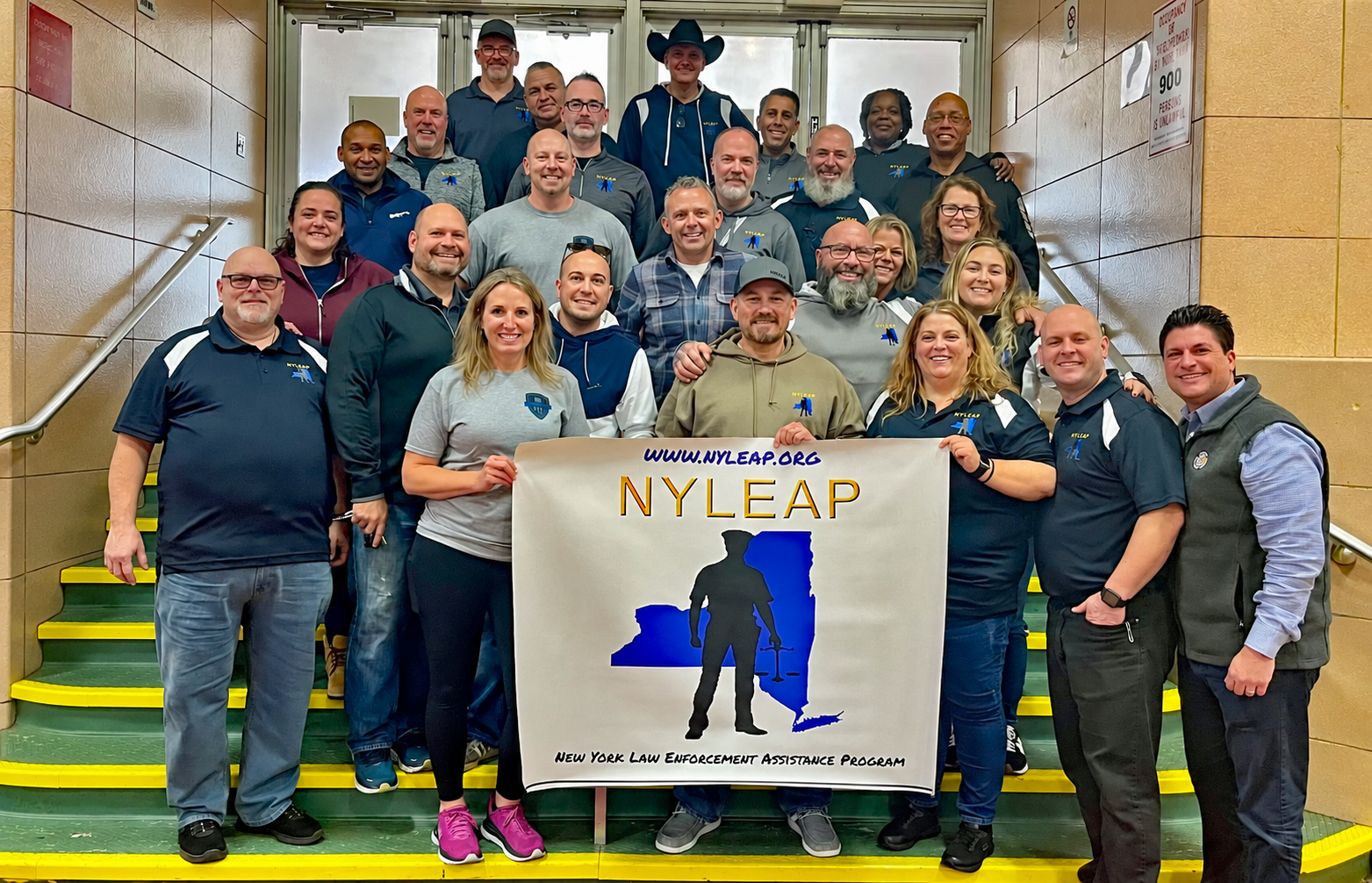 NYLEAP peers standing together with the NYLEAP banner