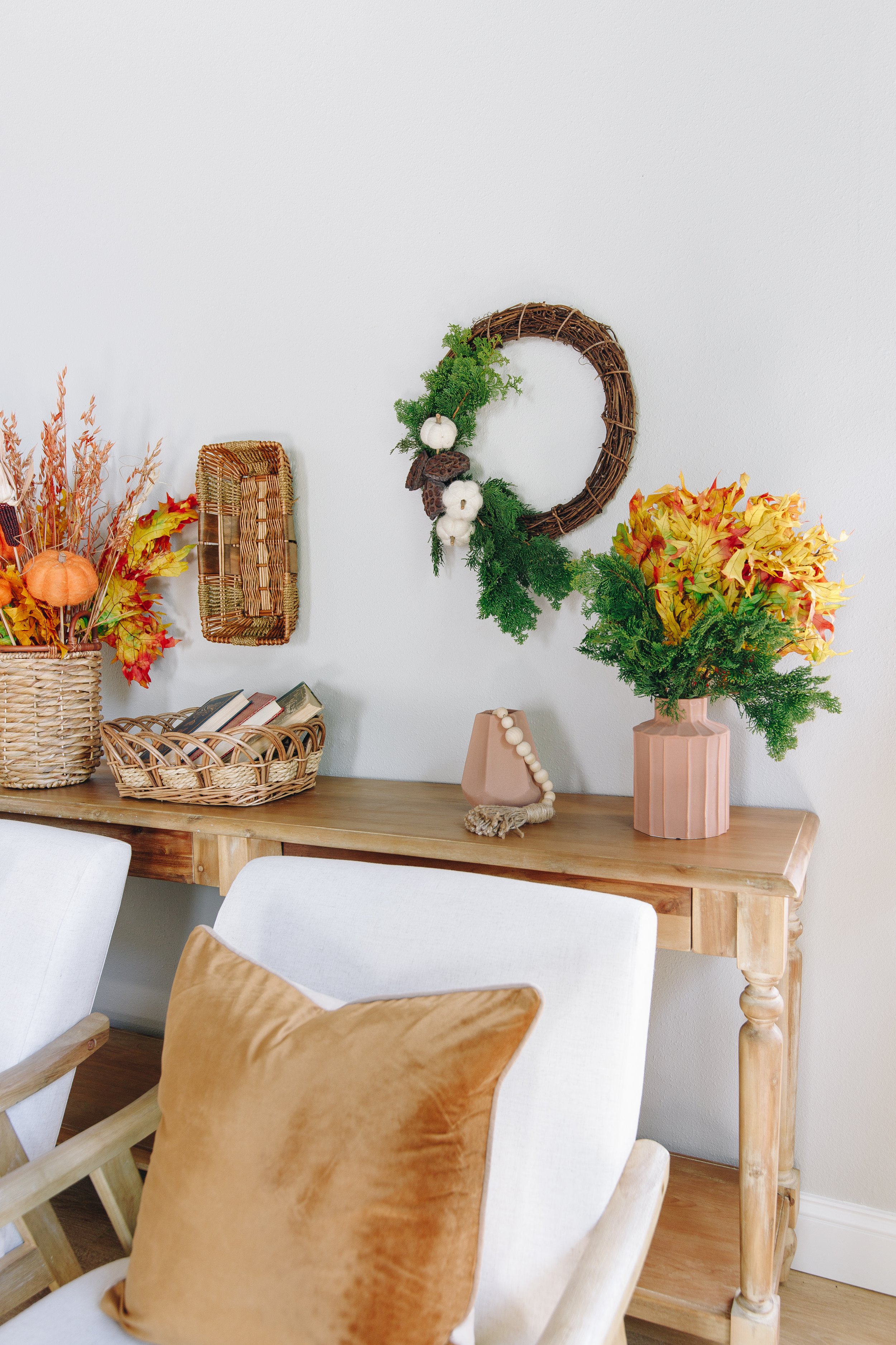 faux branches with dried lotus pods and pumpkins for a cottage wreath