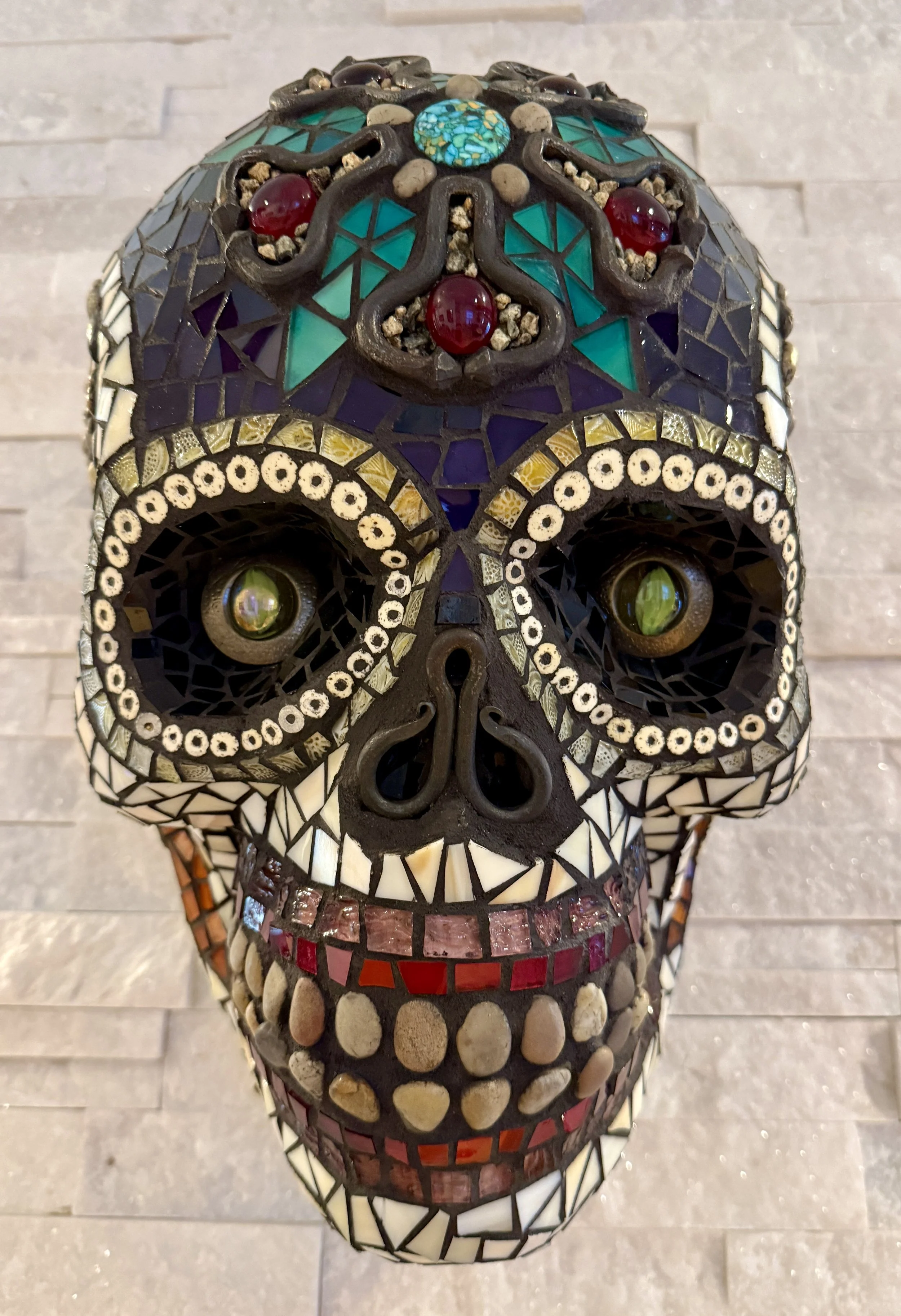 'Muerte Natural' Mosaic skull 
mixed media: stained glass, natural stones, metal hardware, beads. 
15"h x 10"w x 9"d. 