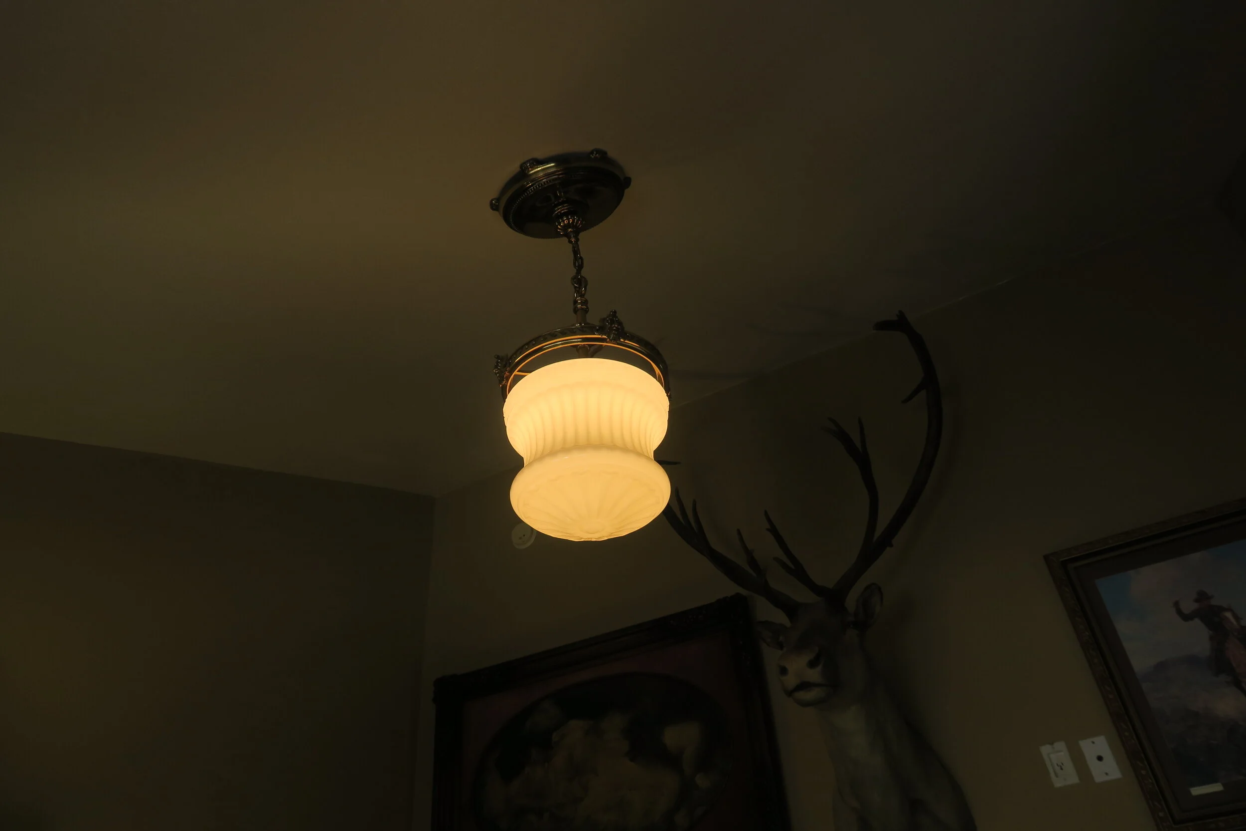 Partial Pair of Opaque Glass Pendant Lights with North Wind Accents