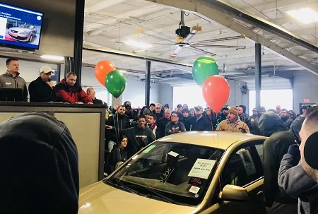 Dealers at Akron Auto Auction gathered around for the auction of 2009 Kia Rio, donated by Bill Doraty Kia, as a charity benefit for a Katie Hominksy, who suffers from multiple sclerosis. The auction raised more than $6,000 to help with her medical expenses.