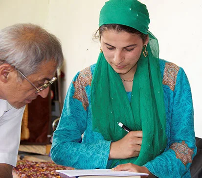 TNMAC’s Victim Assistance Coordinator Alisho Shomahmadov, signing a small grant contract with a landmine victim in the Rasht Valley.