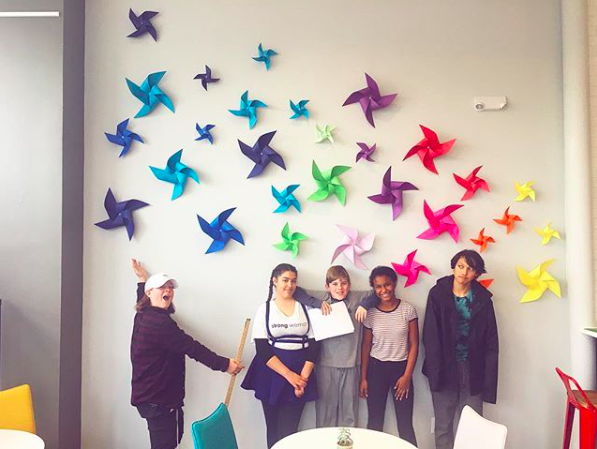 DMHS Students posing in front of the completeed feature wall! 