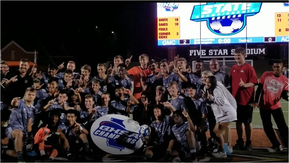 GMC finds energy boost late, scores twice in OT to top ACE and win second straight state boys soccer title