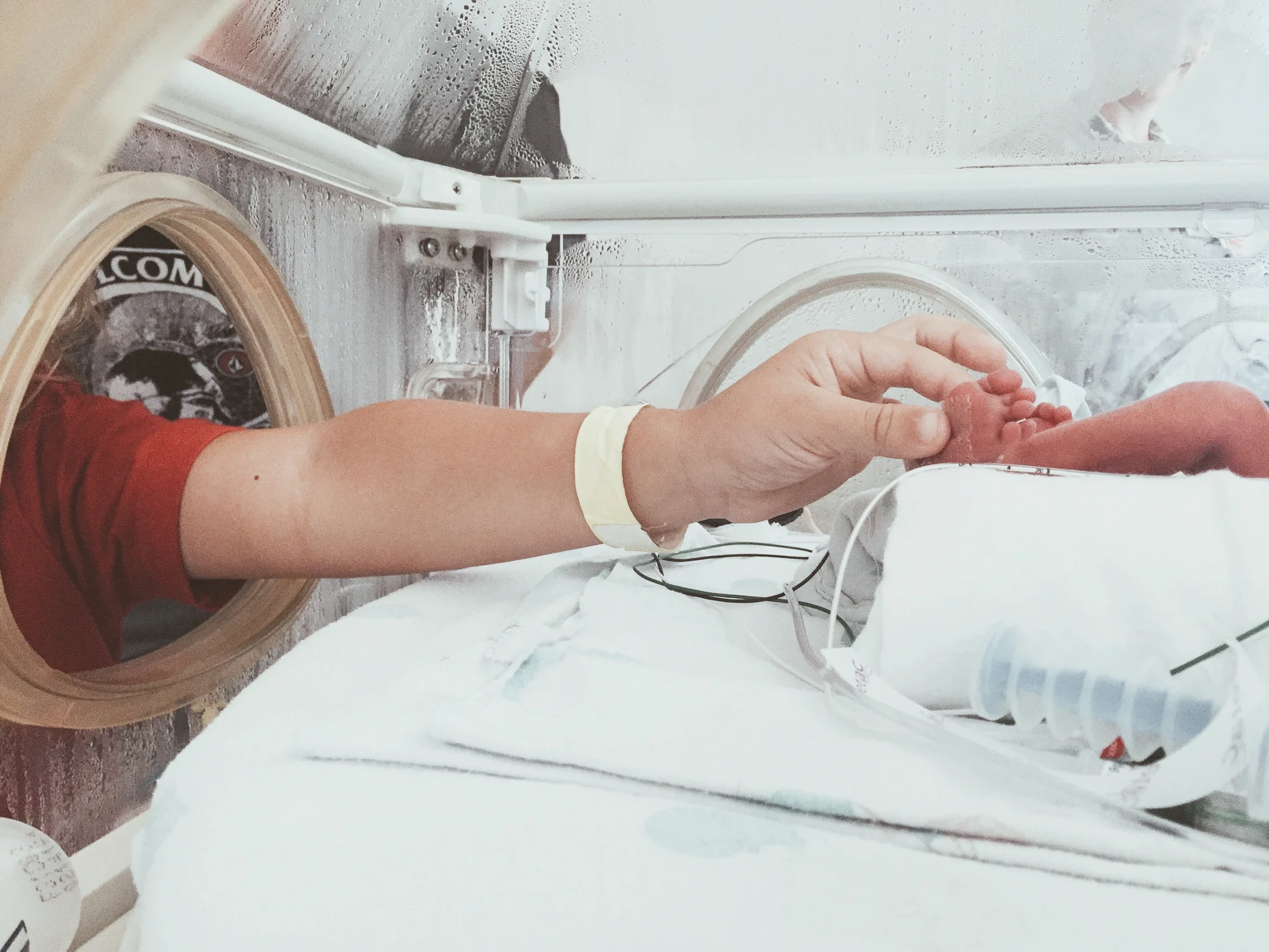 Gideon, 28 weeker, being held by his big borther, Jacob.