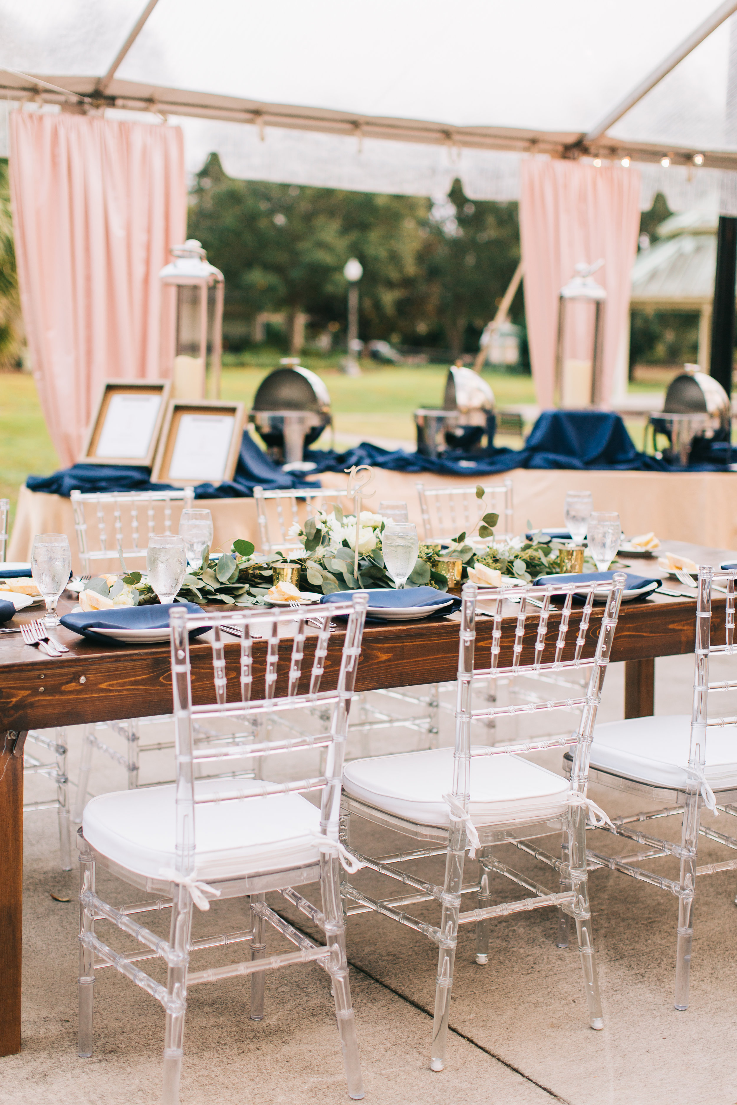  Clear chairs with blush and navy accents 