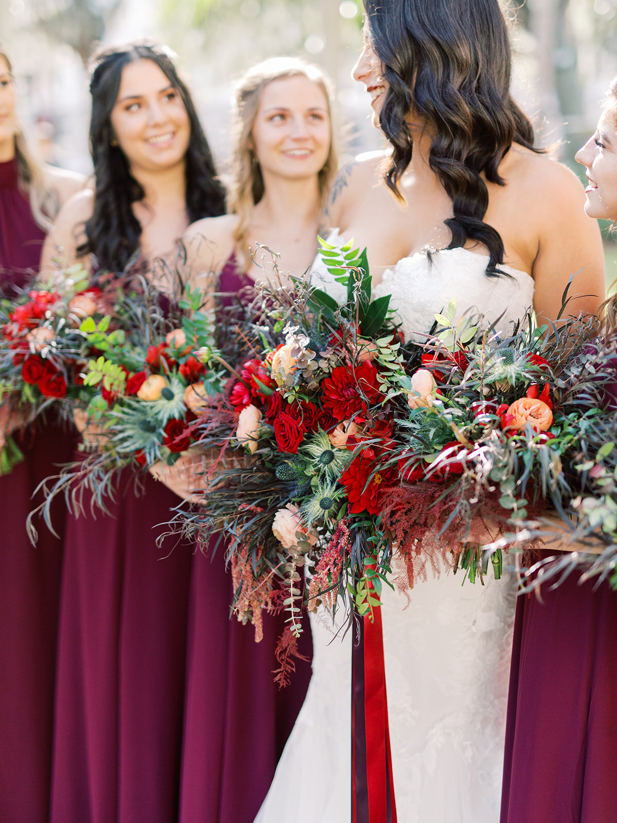 Bouquets with deep fall colors and different types of greenery