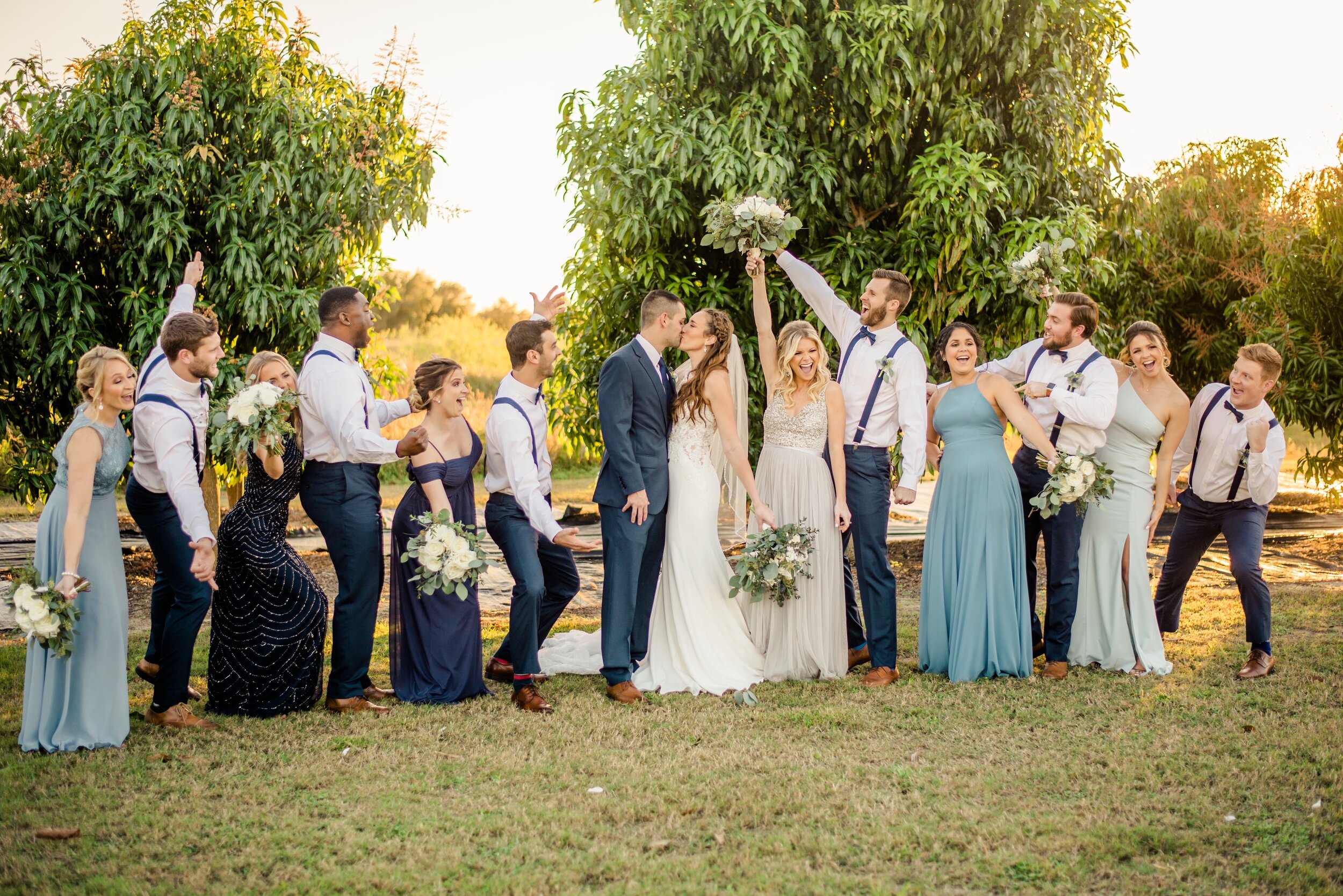 The beautiful bridal party in shades of blue with green and white flowers