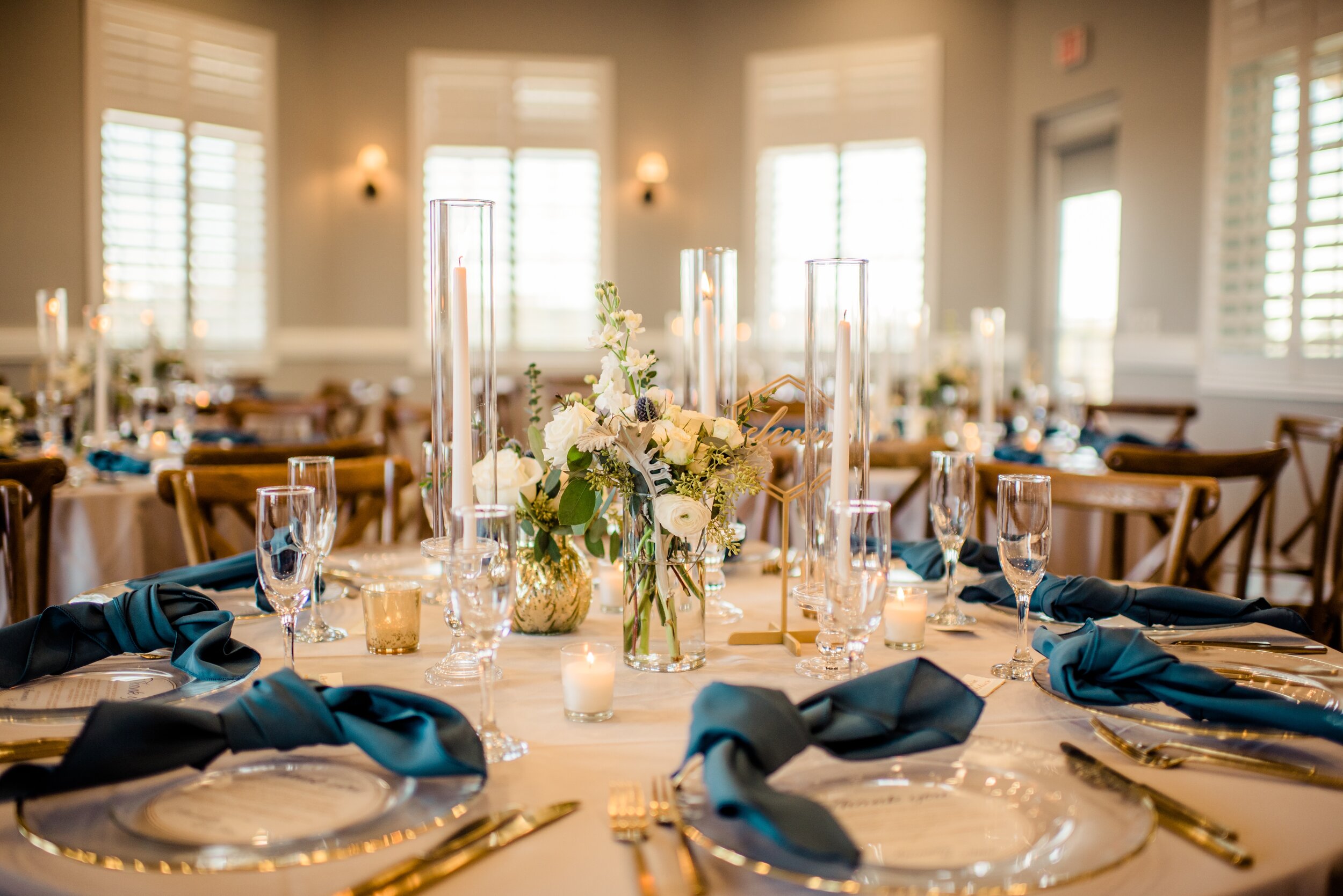 Textured Centerpieces with Blue Napkins and Gold Accent