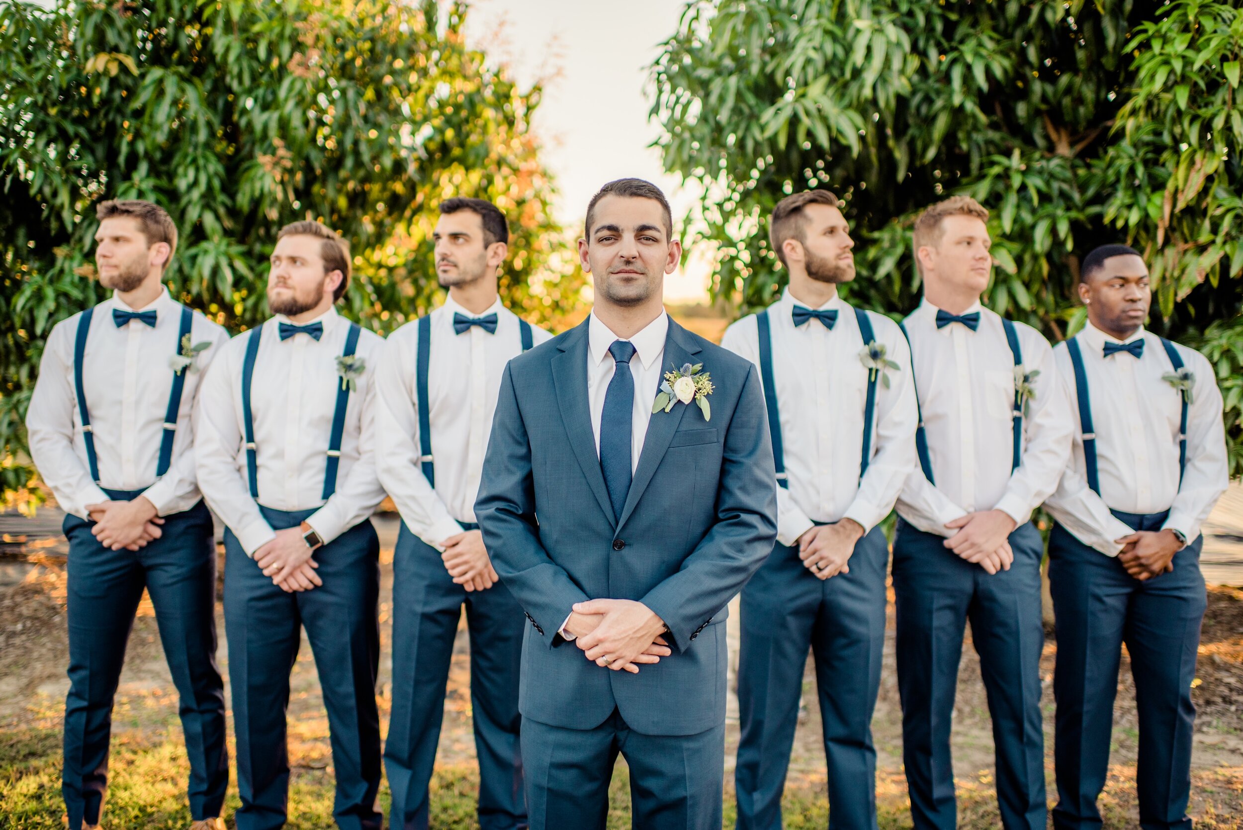 Groom and Groomsmen in Navy with White and Green boutonnieres