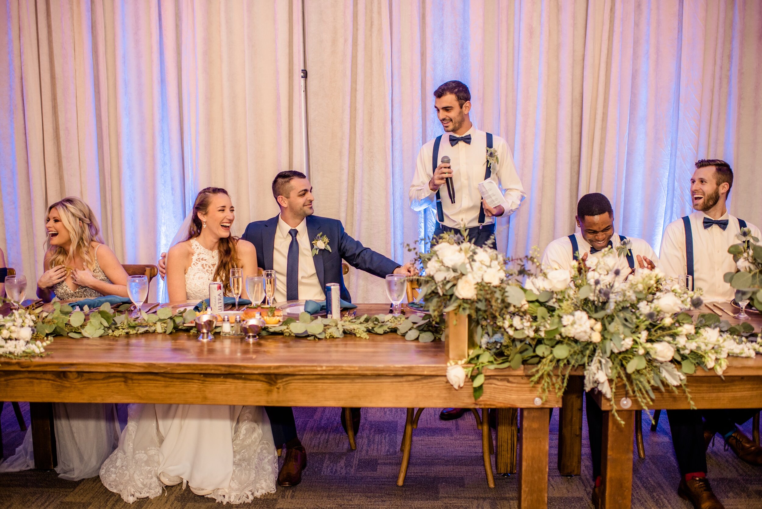 Best man speech at the head table with repurposed floral from the arch