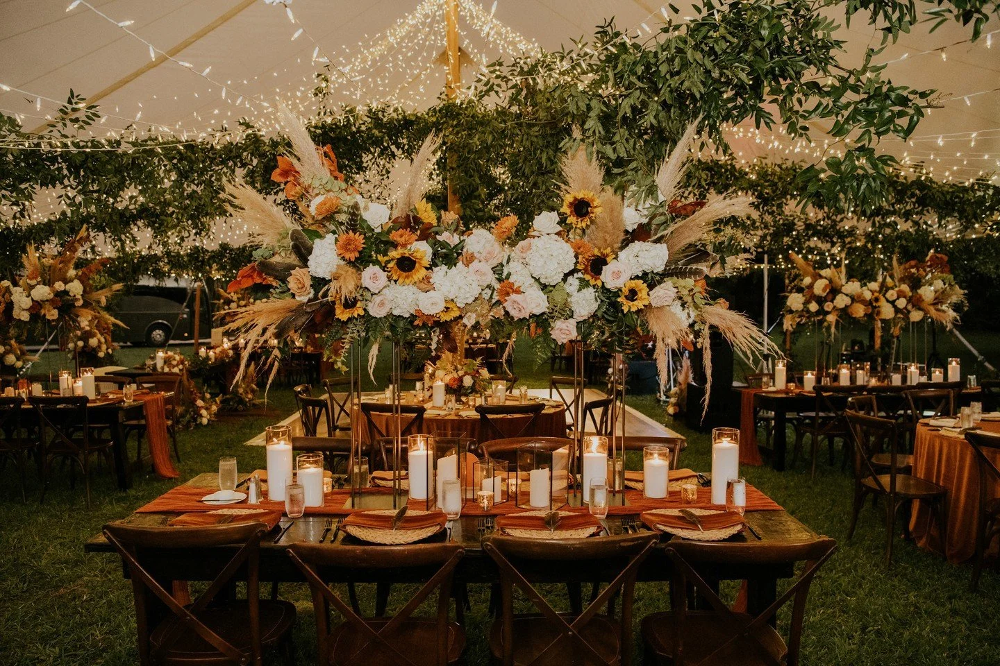 fall-ing for this tent reception✨️🍂 ⁠
⁠
Swipe to see the stunning designs of this beautiful fall wedding day! Our team installed lush greenery strands throughout the tent, suspending it over the beautiful lush floral for a grand organic look!⁠
⁠
Rus