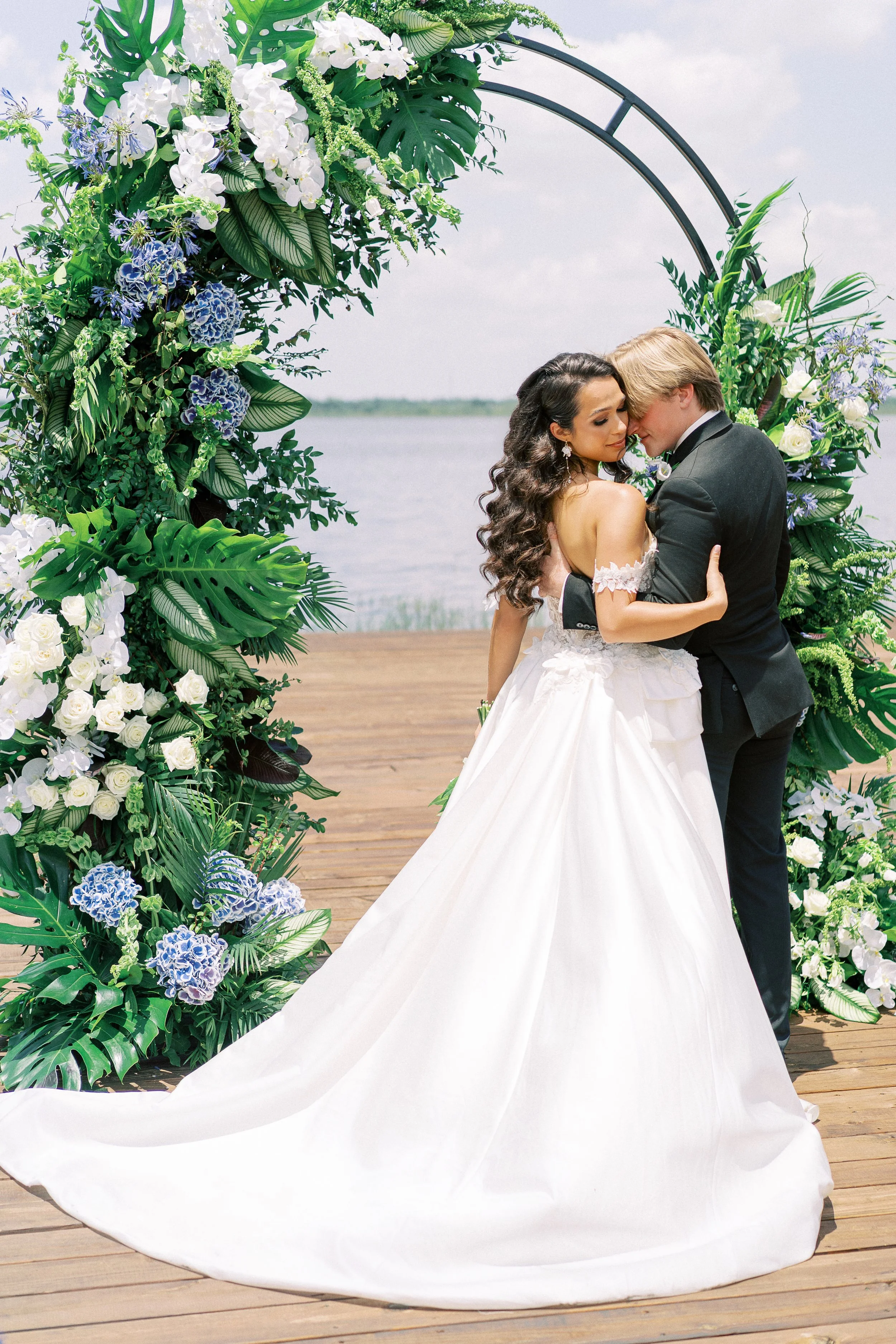 Waterfront Wedding Ceremony with Blue and Green Floral Arch