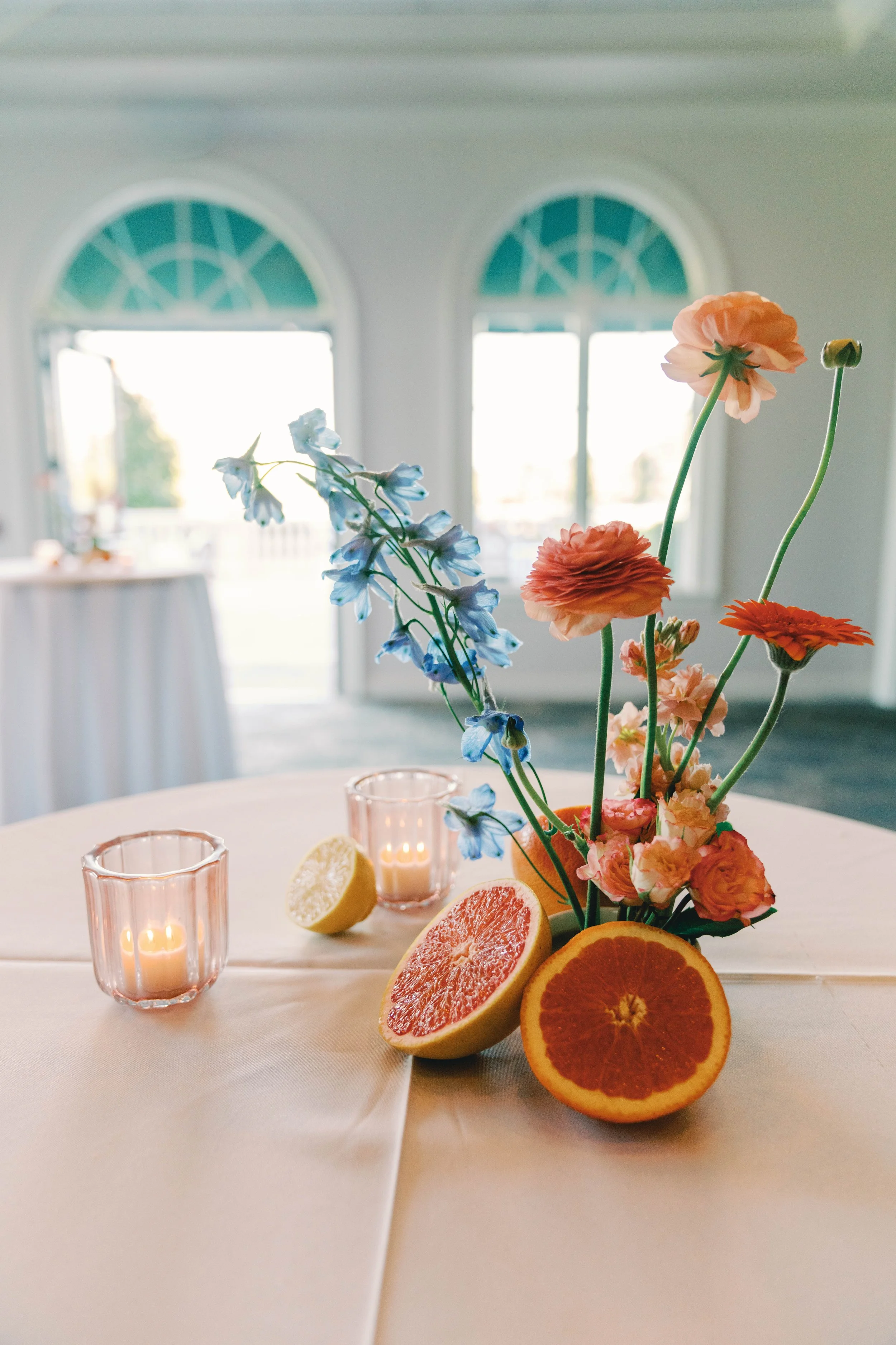 Modern ikebana floral arrangement featuring citrus details and candlelight, designed by Bluegrass Chic, an Orlando event florist.