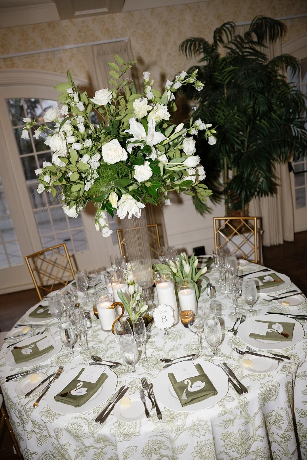 Airy white floral arrangement with sculptural tulips and delicate greenery on a Crane Club wedding table, designed by Bluegrass Chic.