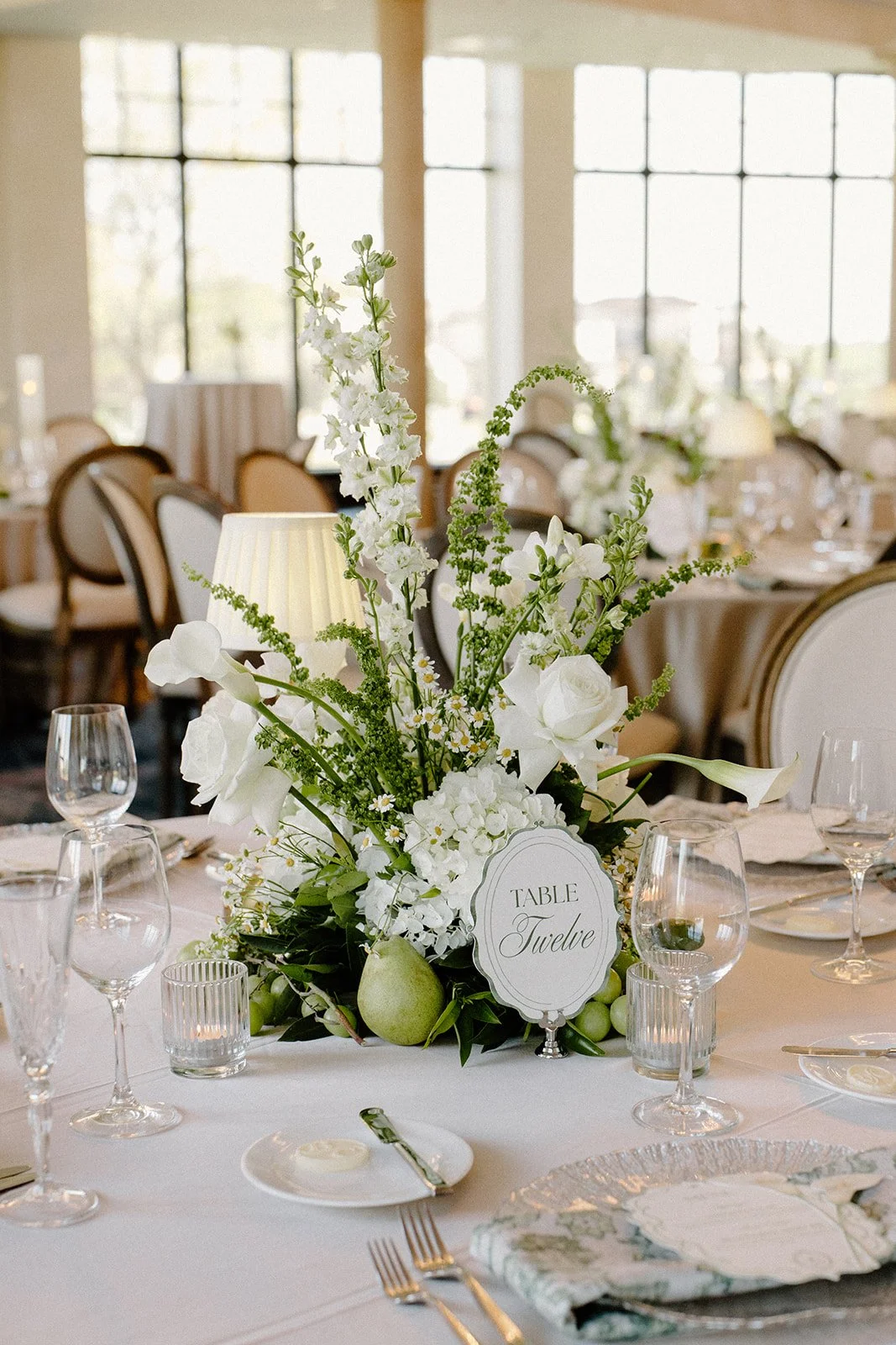 Fruit-forward wedding tablescape with grapes and fabric lamps at Bella Collina