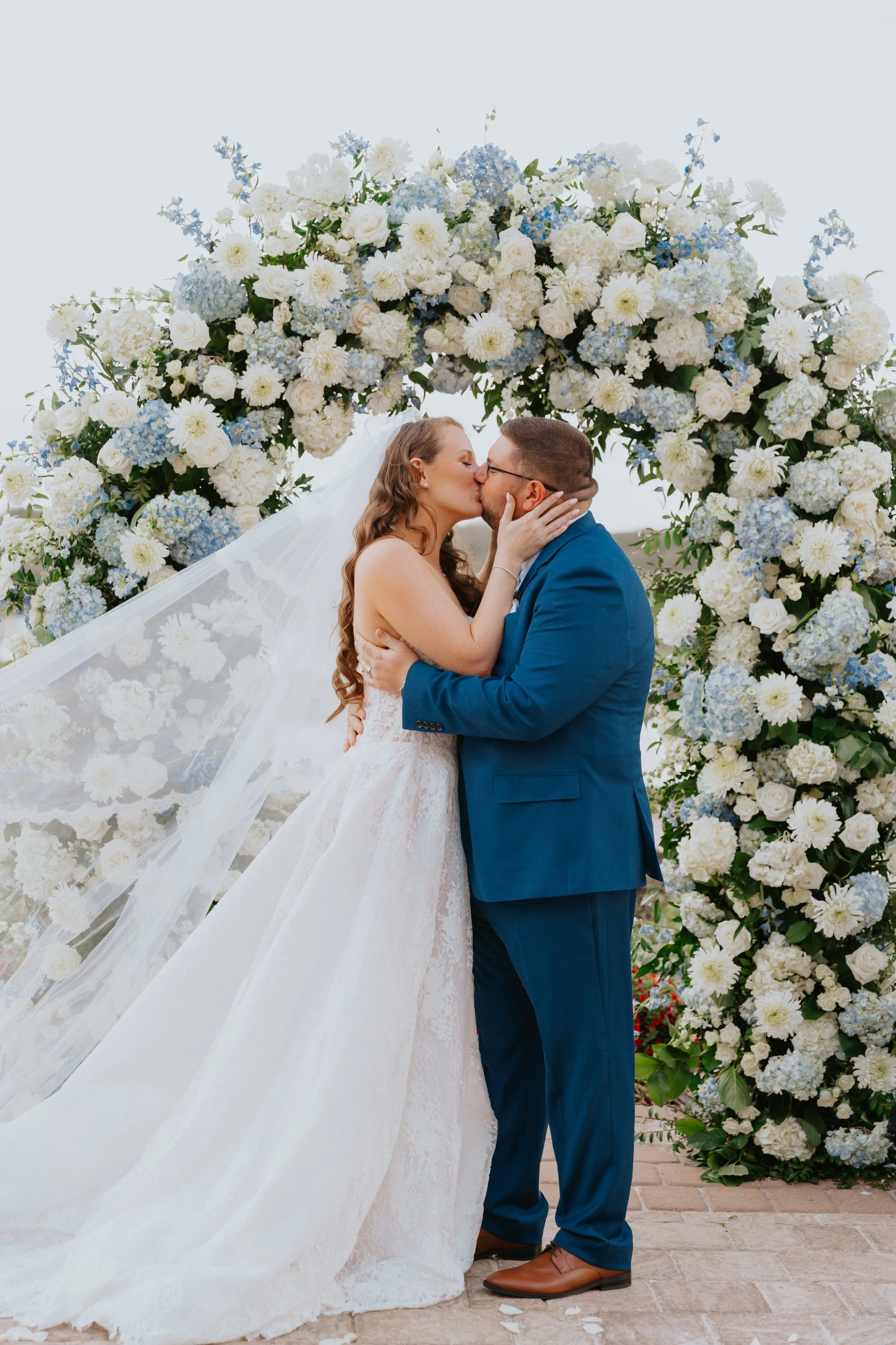 Luxury blue and white wedding ceremony floral arch designed by Bluegrass Chic, an Orlando wedding florist.