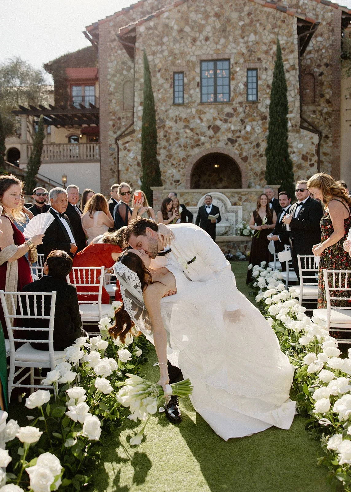 White roses lining an outdoor ceremony at Bella Collina