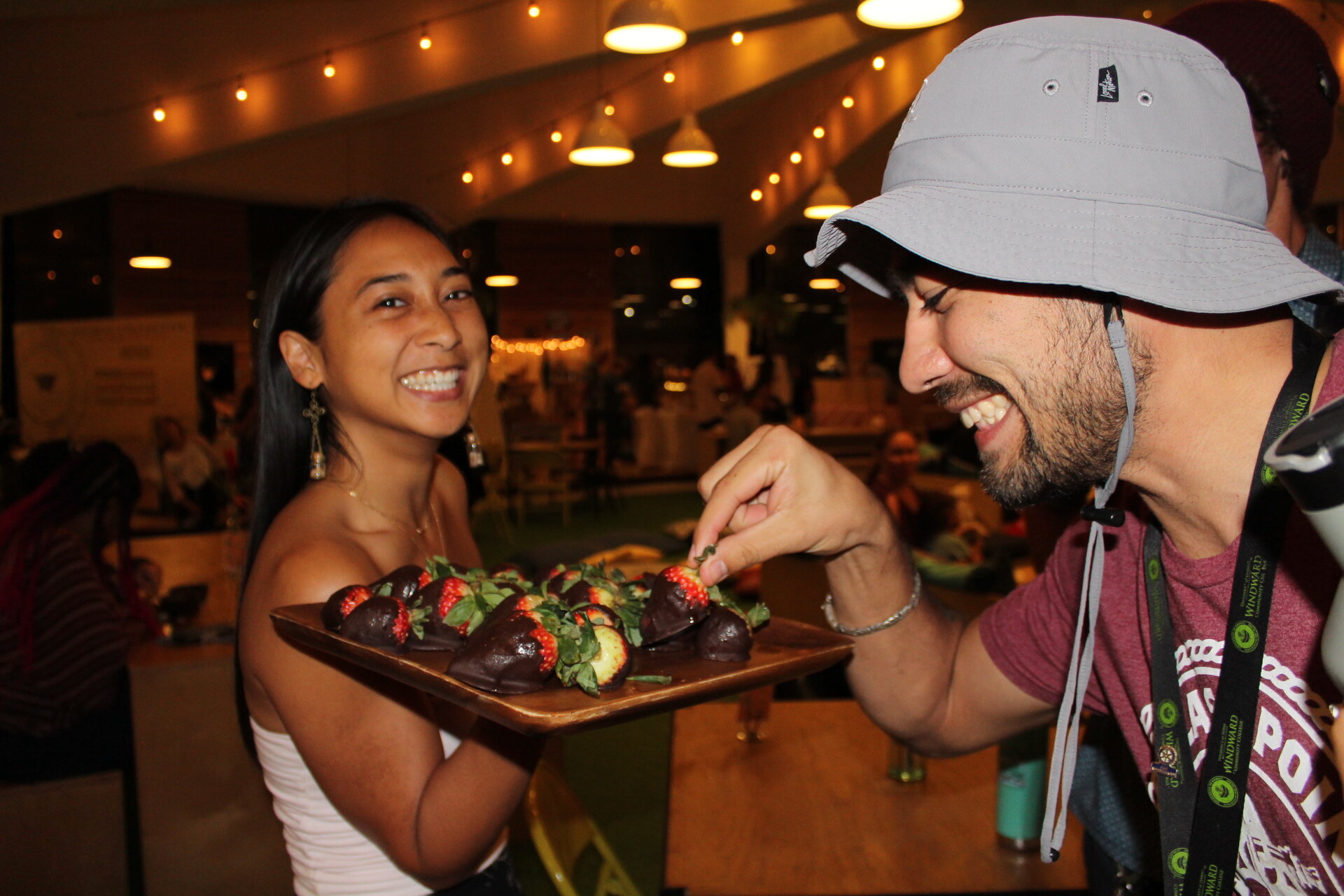 Our Co-Founder Anna Camacho feeding chocolate covered strawberries to partygoers