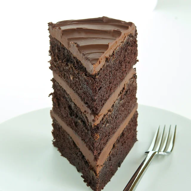 Chocolate Cake Homemade chocolate cake infused with coffee and filed with milk chocolate frosting. Our chocolate frosting pairs perfectly with our wedding vanilla cake.