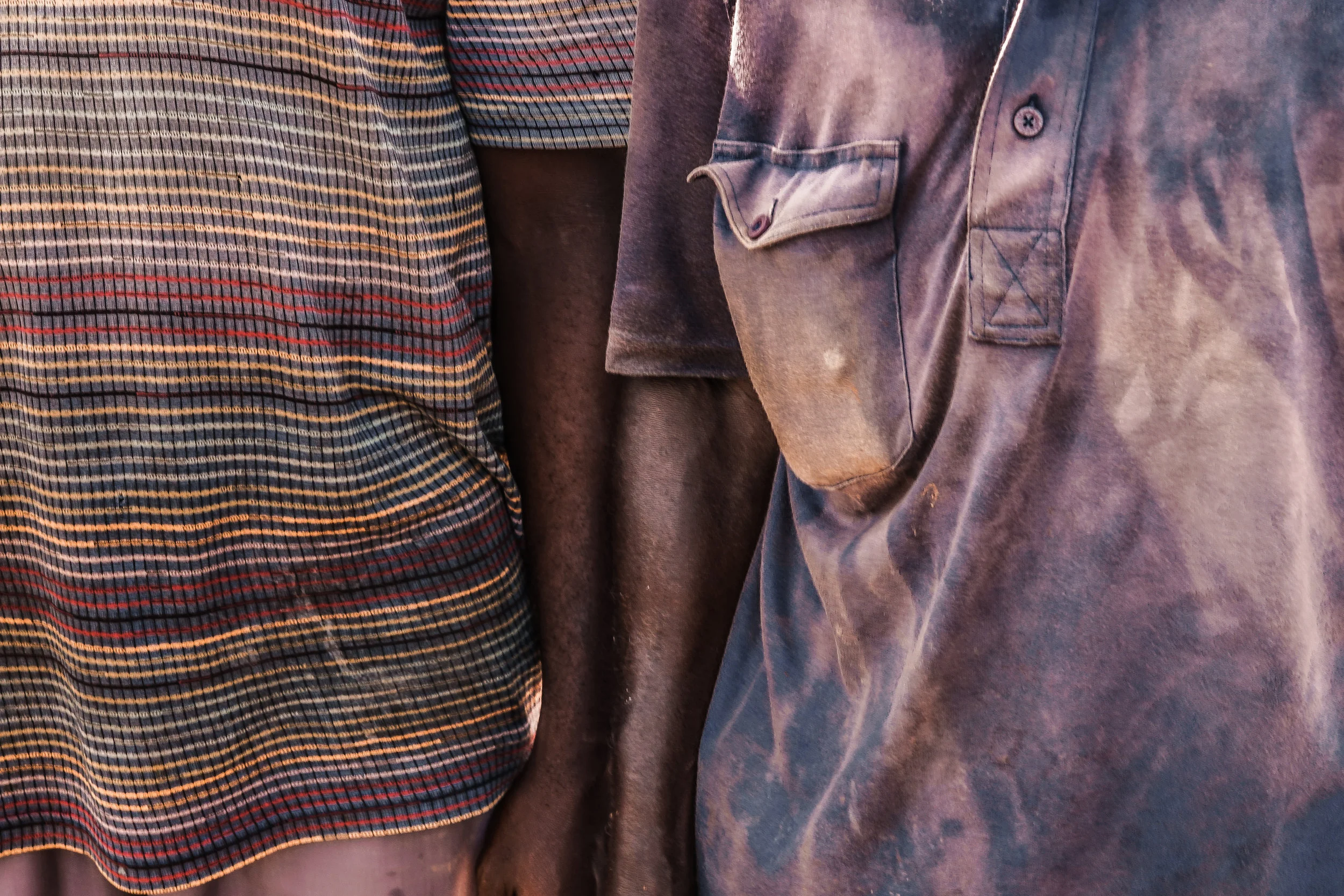  Two farmers stand together facing adverse agricultural challenges. Kwame and Kojo express worryingly how climate change and Accra's increasing urbanization reduce the city's arable soil. 
