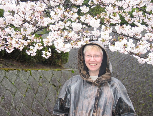The artist in Japan - wearing the raincoat that inspired the collection.