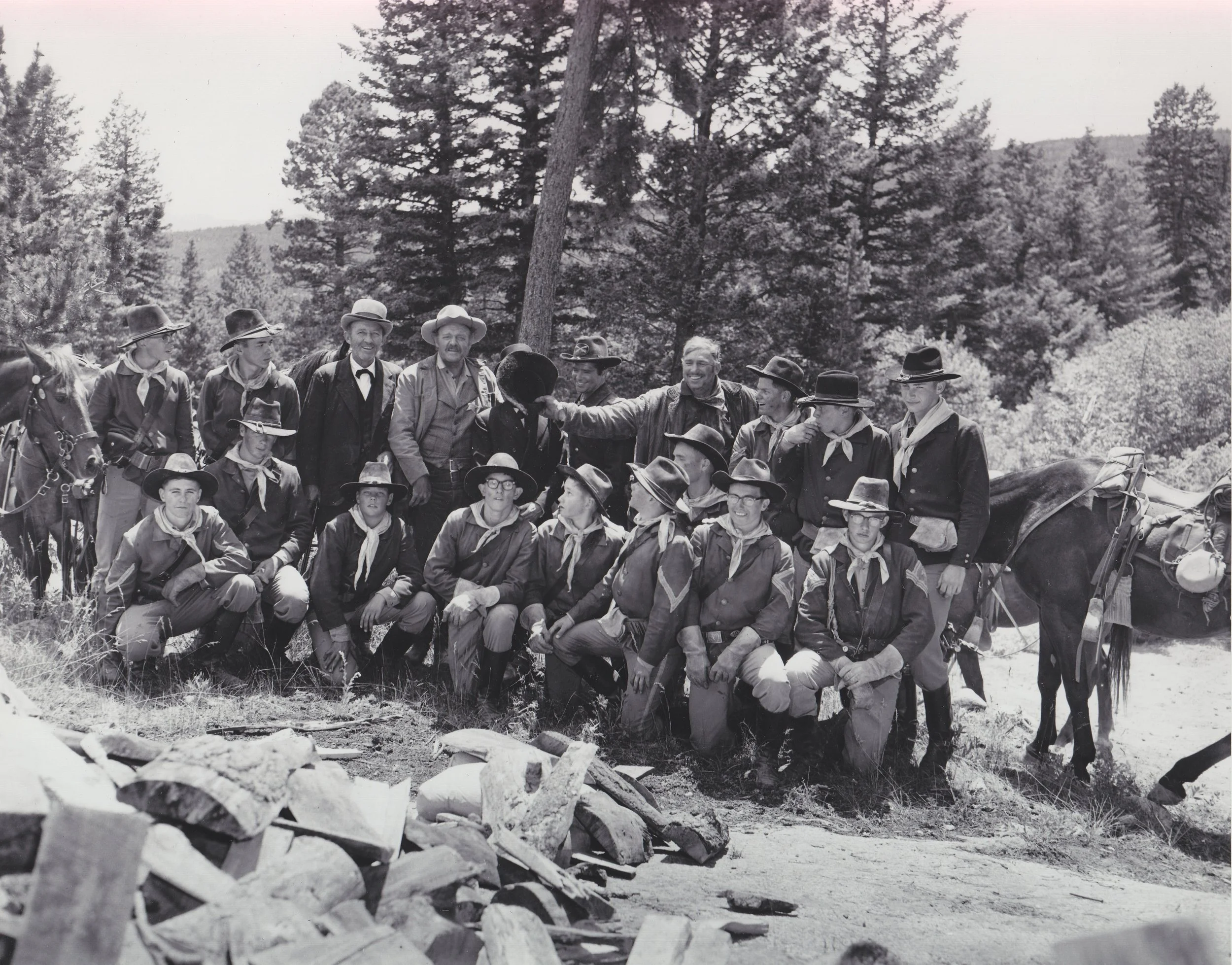 The Westernaires Cavalry team takes a break from shooting Stagecoach (1966). Centered in the top row, the stars (left to right) are: Bing Crosby, Van Heflin, Red Buttons (with his face covered), Joseph Hoover, and Slim Pickens (clowning around).