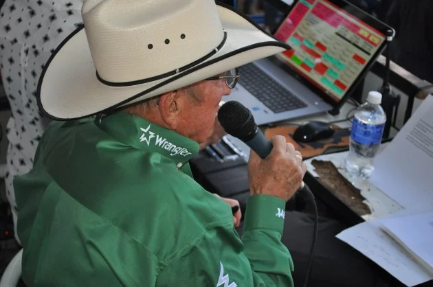 Hadley Barrett in action in the announcer's booth at Denver's National Western Stock Show & Rodeo. Photo courtesy of Tom Harding, TSM via K99 Radio .