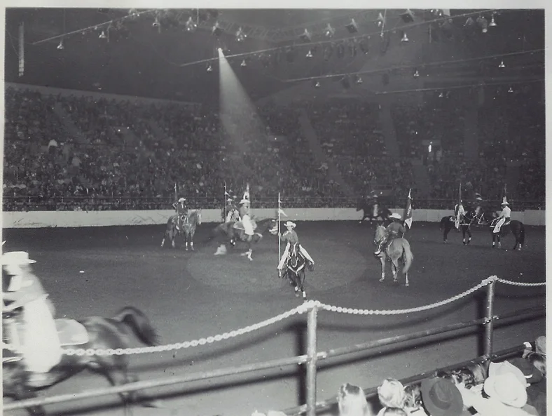 The Westernaires put in seven appearances at the 1955 National Western Stock Show in Denver. Here, the 30-rider precision drill team executes the "Gear Wheels" maneuver.
